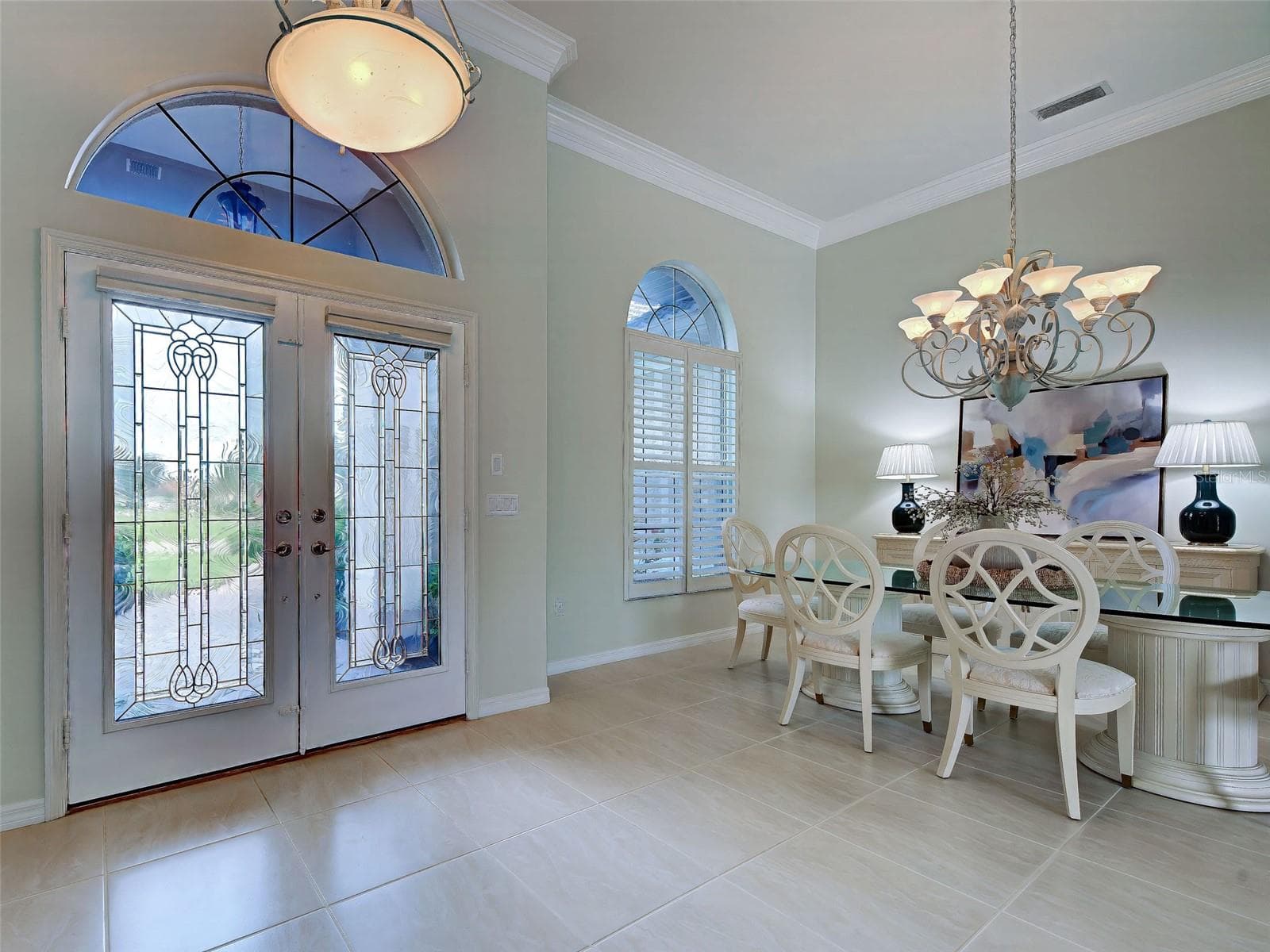 Welcoming foyer with double doors and dining room; so much natural light. - 692 EGRET WALK LN, VENICE