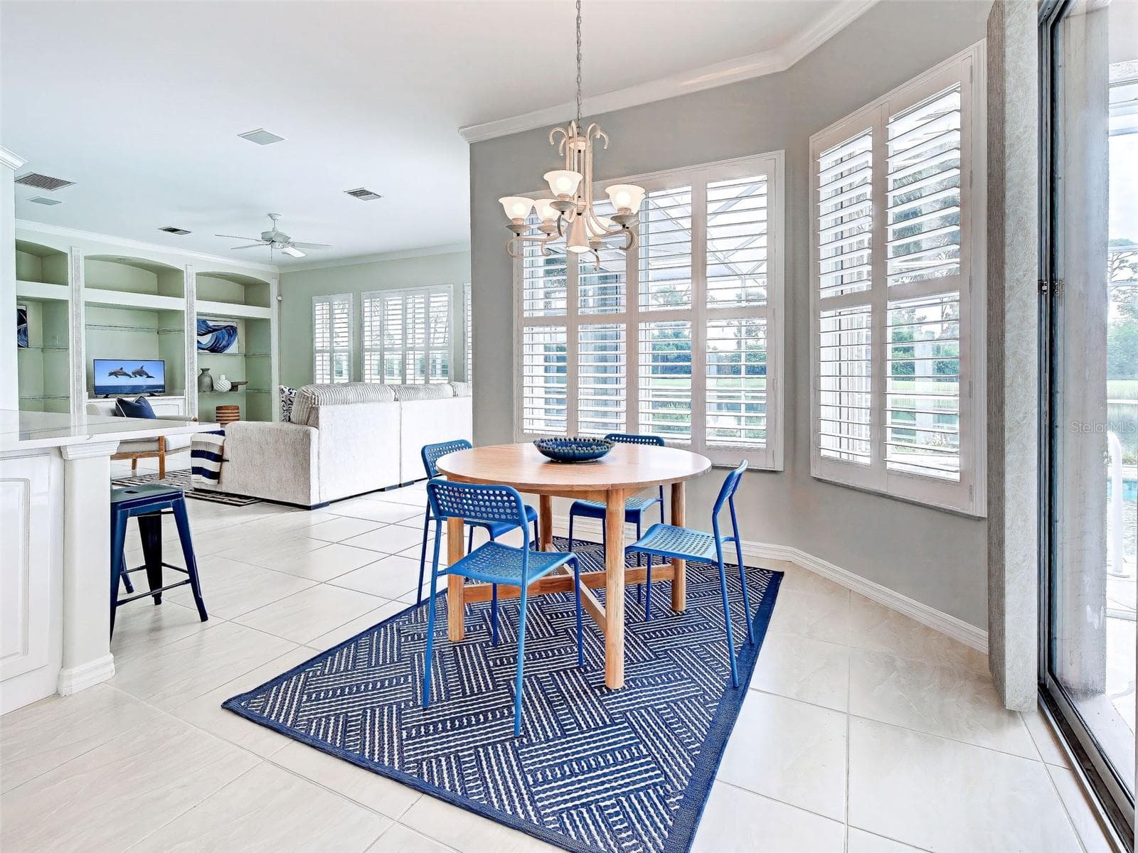 Kitchen area flows beautifully to the spacious family room.  Crown molding and plantation shutter throughout make this lovely home so classy. - 692 EGRET WALK LN, VENICE