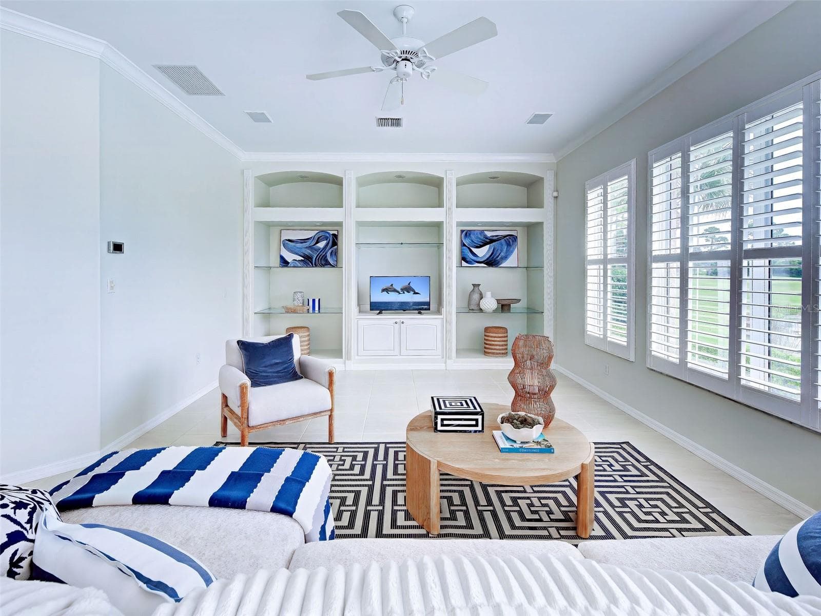 Enjoy a favorite movie or cheer on your team in the large family room with built ins. - 692 EGRET WALK LN, VENICE