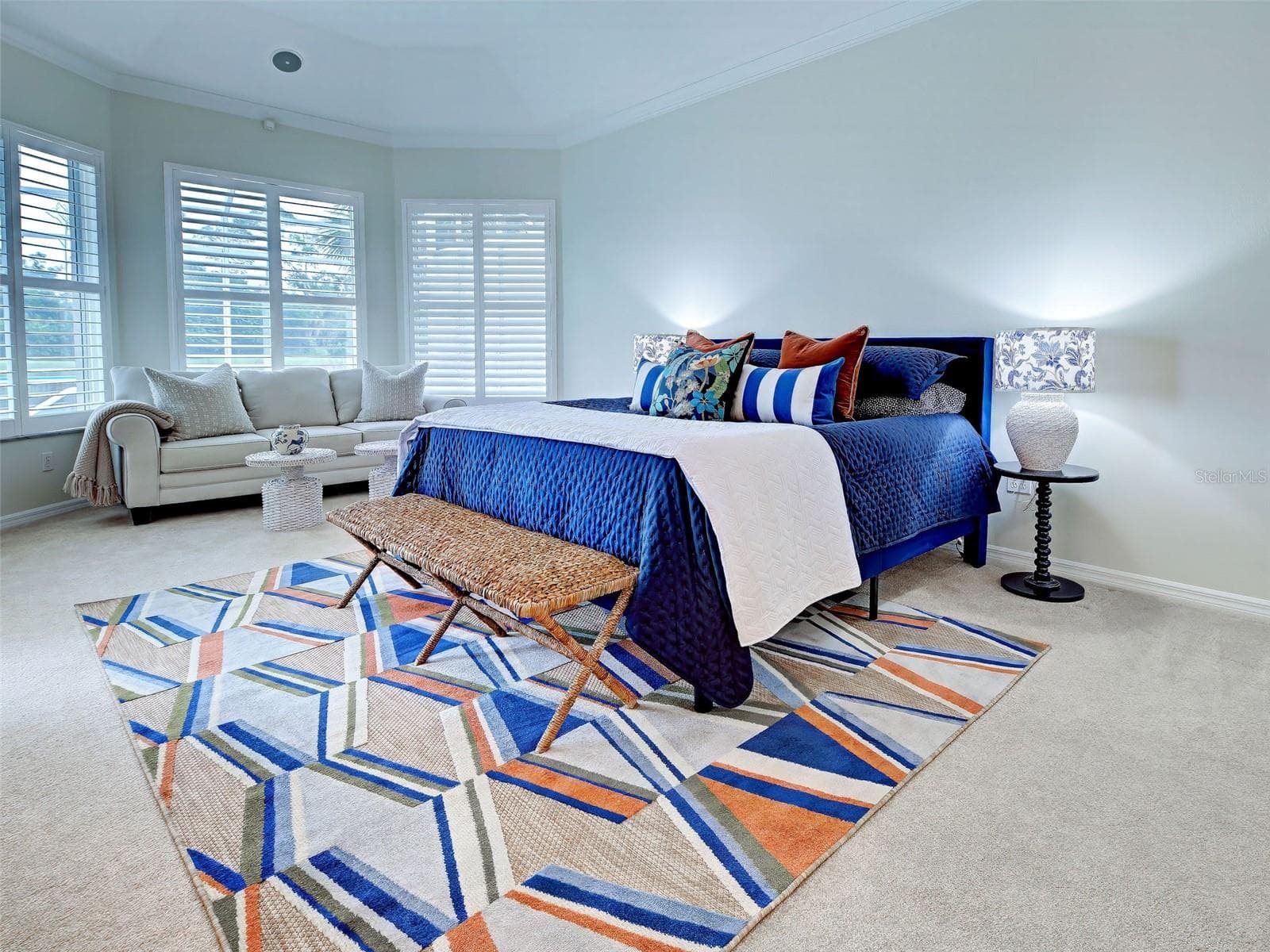 Drift off to sleep in the primary bedroom which overlooks the lake/golf course and has newer carpet and plantation shutters. - 692 EGRET WALK LN, VENICE