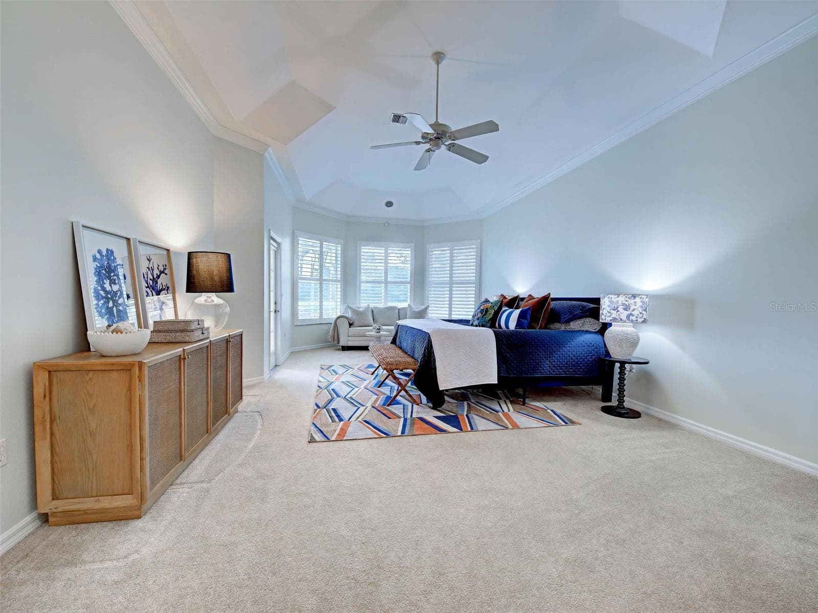 Primary bedroom is enormous and features tray ceilings and door for easy access to the lanai. - 692 EGRET WALK LN, VENICE