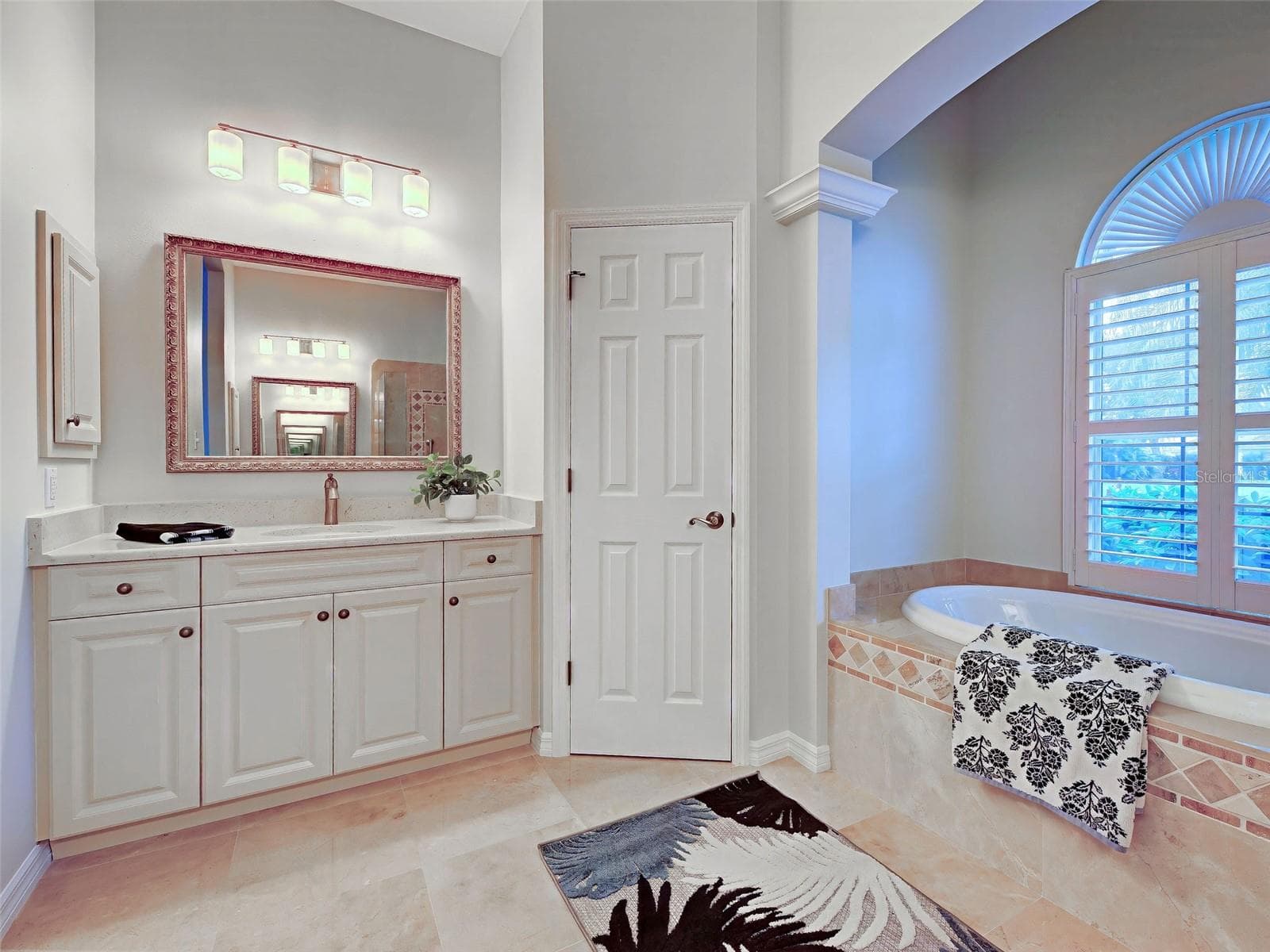 Primary ensuite bathroom features dual, split vanities, private commode and garden tub. - 692 EGRET WALK LN, VENICE