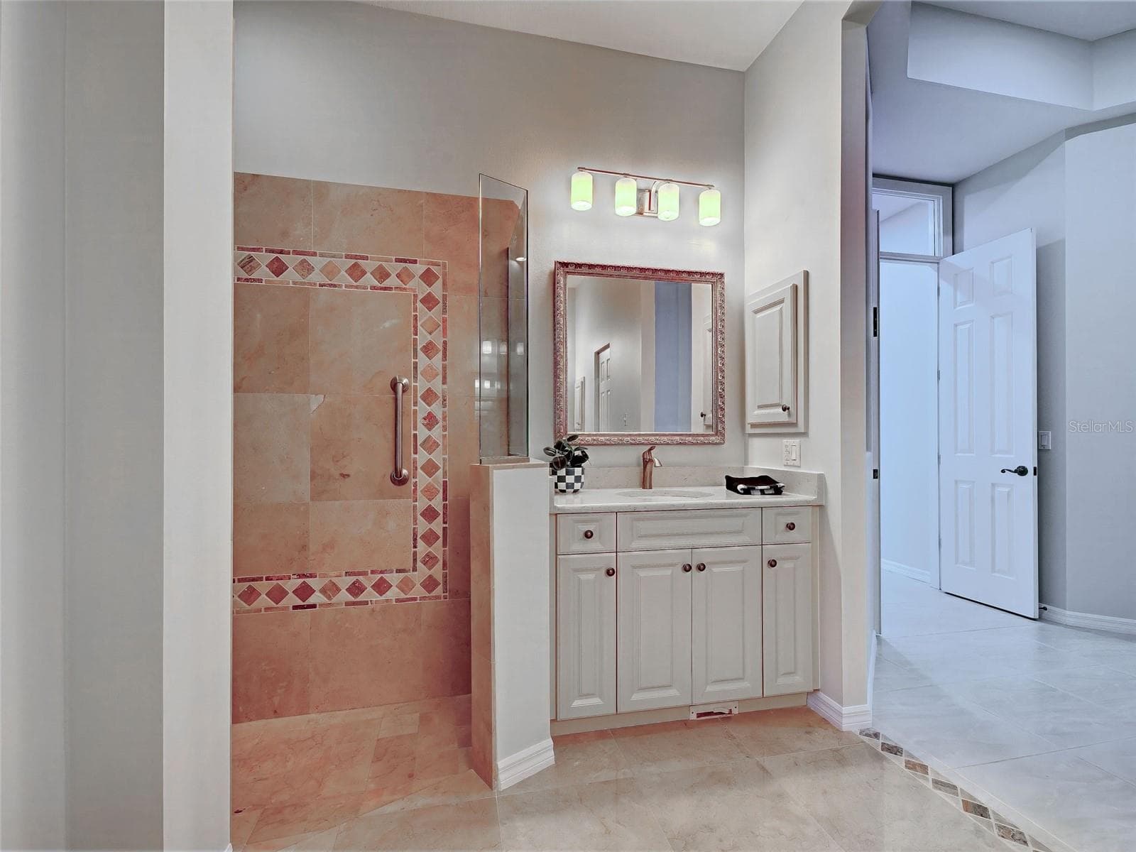 Primary bathroom has plenty of storage space and new light fixtures. - 692 EGRET WALK LN, VENICE
