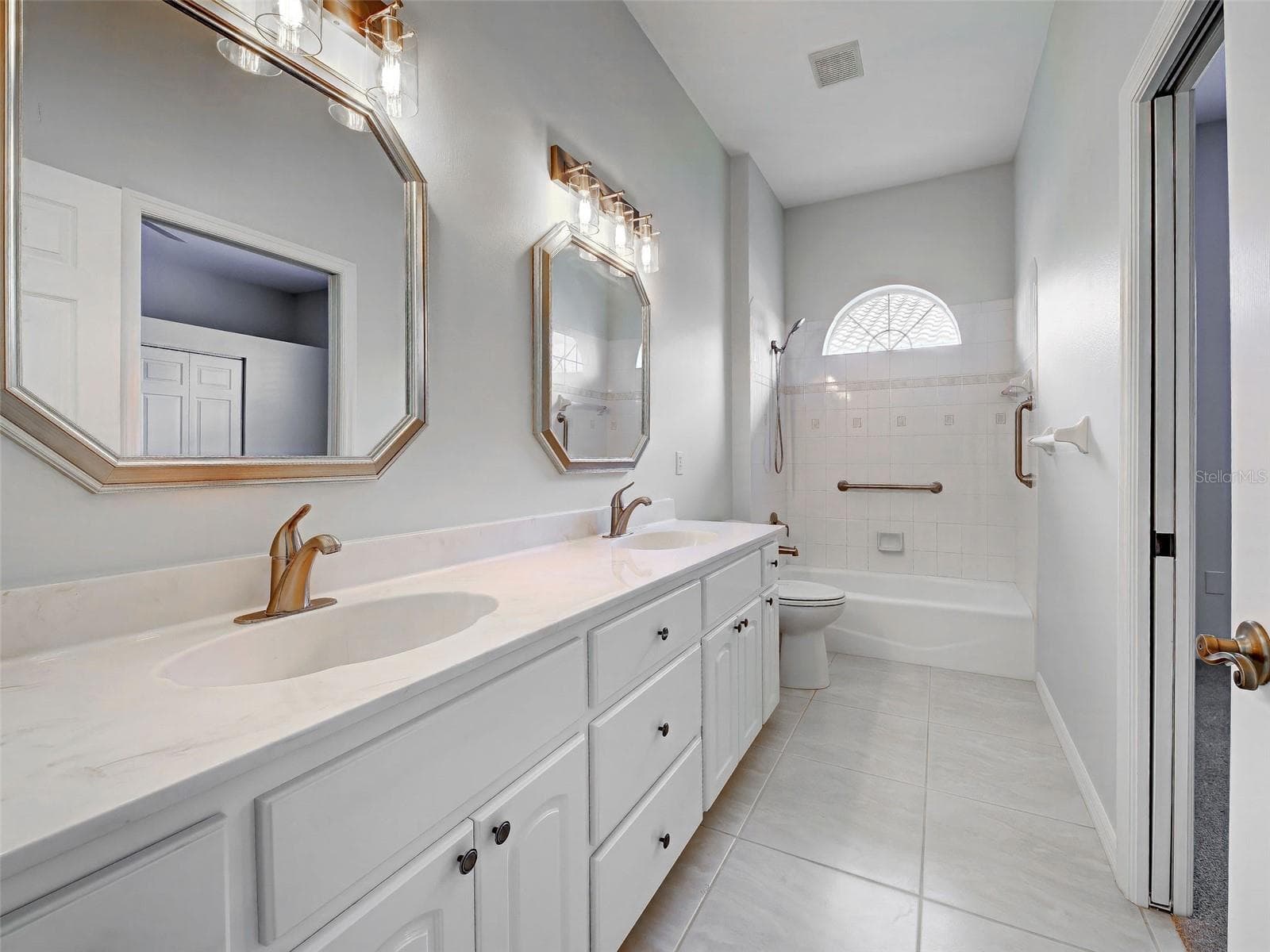 2nd bedroom's ensuite bathroom is so roomy with dual sinks and so much storage space. - 692 EGRET WALK LN, VENICE