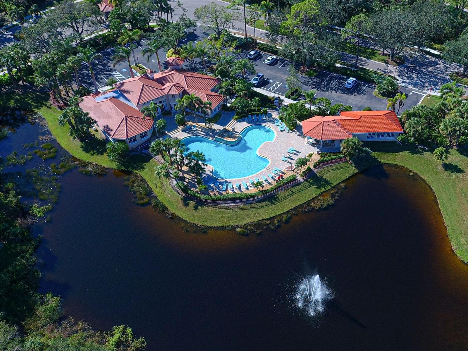 Bird's eye view of Sawgrass clubhouse, pool and fitness with lake, fountain and golf views. - 692 EGRET WALK LN, VENICE