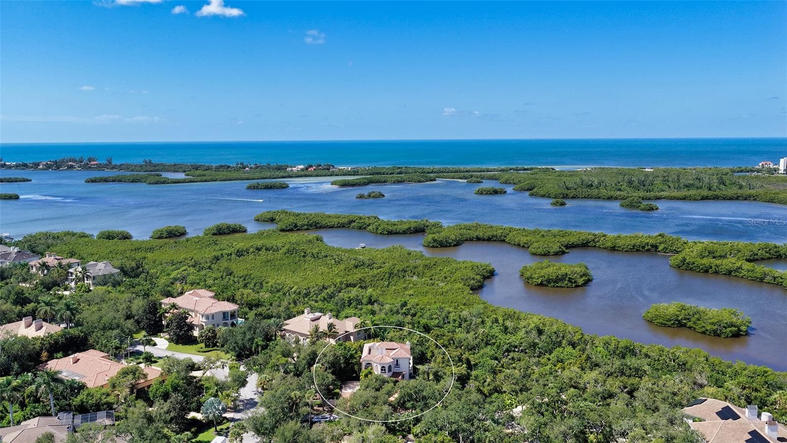 Sweeping aerial views showcase the extraordinary natural setting along Little Sarasota Bay and the surrounding coastal landscape. - 168 COASTAL HAMMOCK CT, OSPREY