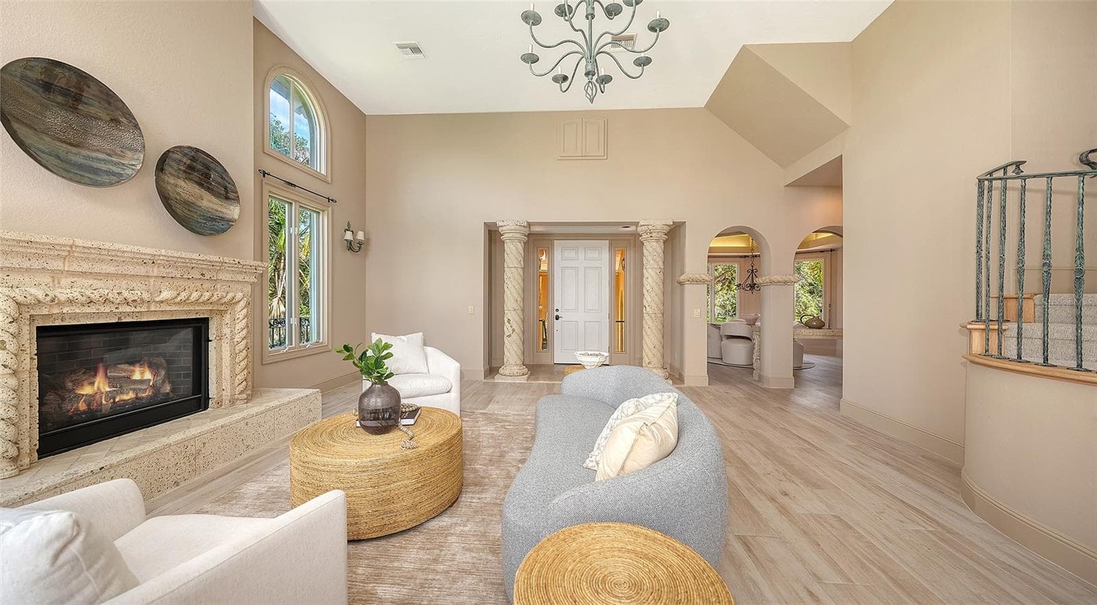 A fireplace, custom millwork and graceful architectural elements bring warmth and character to the main living area. - 168 COASTAL HAMMOCK CT, OSPREY