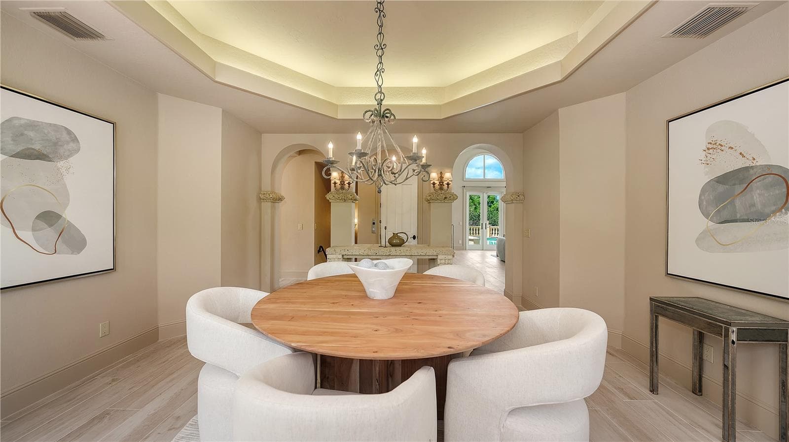 The dining room's graceful proportions and architectural detailing create an inviting space for memorable gatherings. - 168 COASTAL HAMMOCK CT, OSPREY