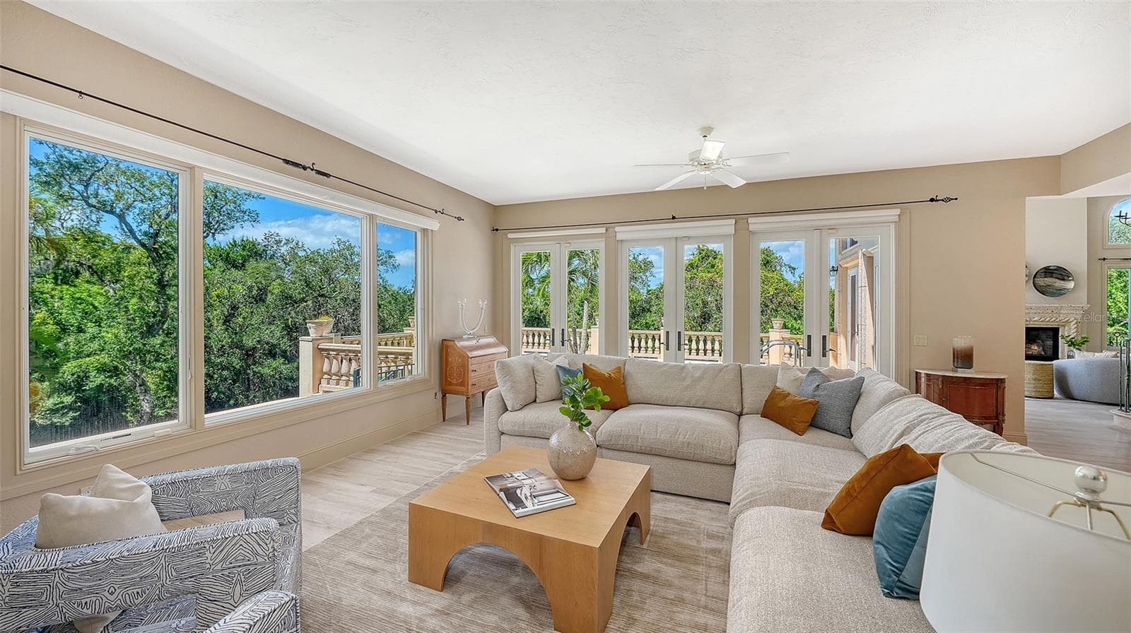 French doors and oversized windows bring the beauty of the surrounding landscape into the home's main gathering areas. - 168 COASTAL HAMMOCK CT, OSPREY