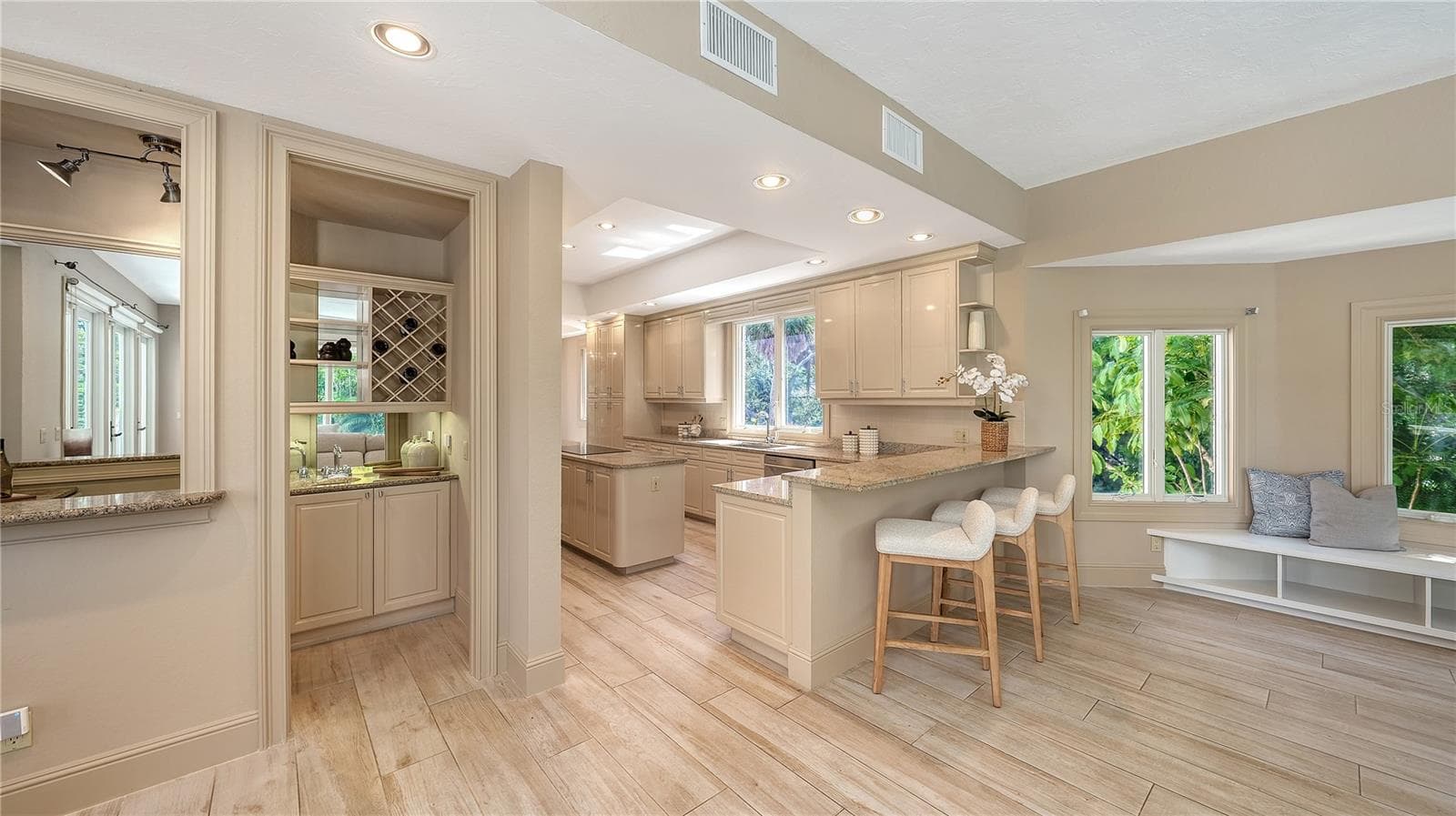 The kitchen opens naturally to the surrounding living spaces, creating an easy flow for everyday living and entertaining. - 168 COASTAL HAMMOCK CT, OSPREY
