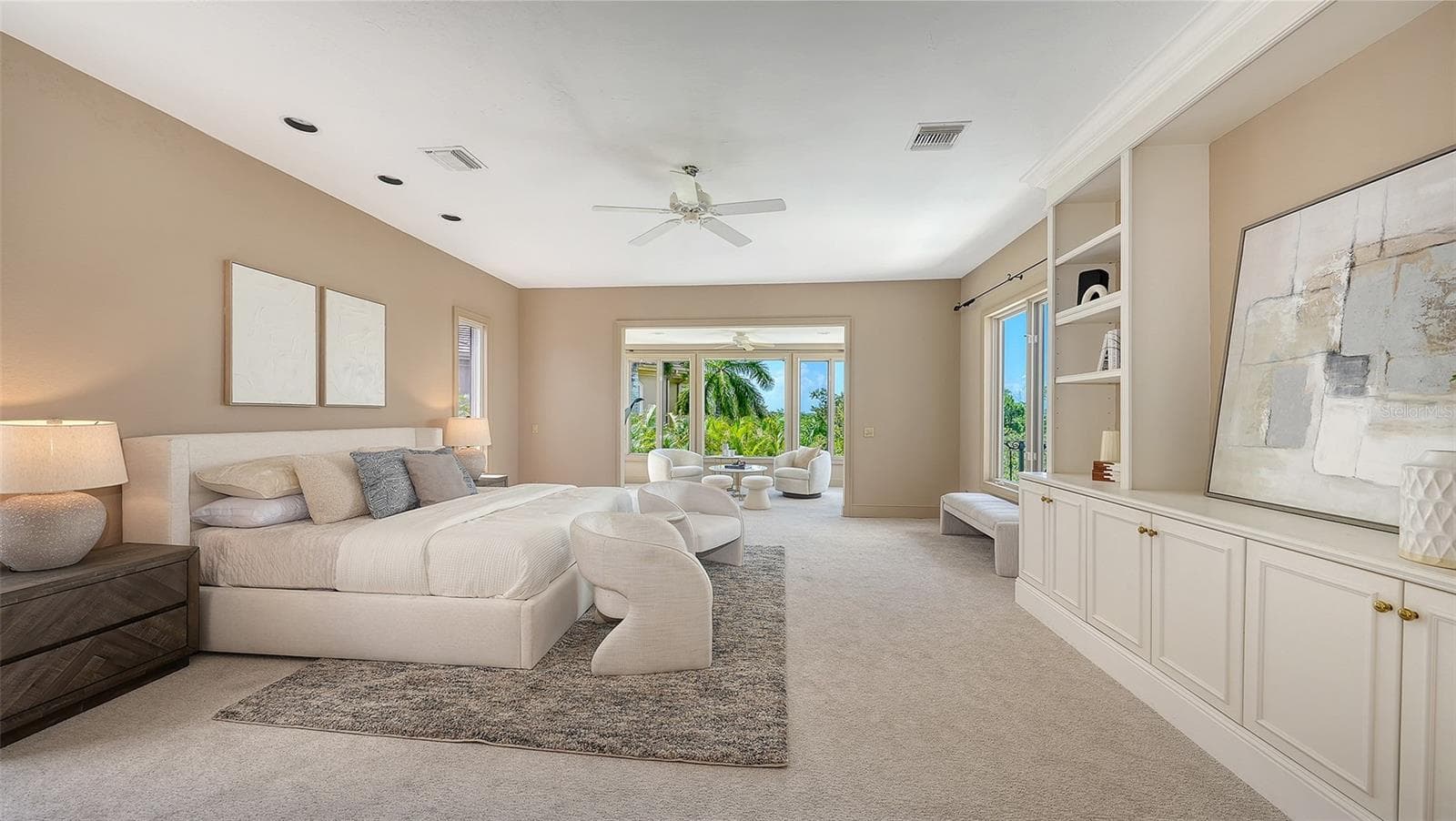 The primary suite occupies its own private level with generous proportions, custom built ins and a separate sitting area. - 168 COASTAL HAMMOCK CT, OSPREY