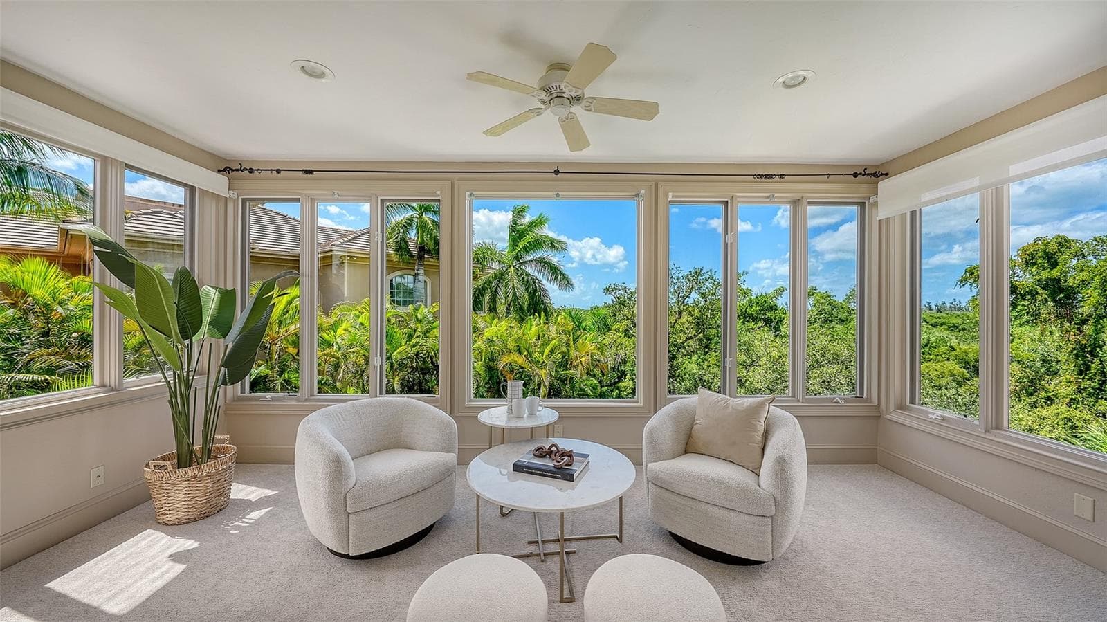 A light filled sitting area within the primary suite provides a serene place to relax while enjoying views of the tropical surroundings. - 168 COASTAL HAMMOCK CT, OSPREY