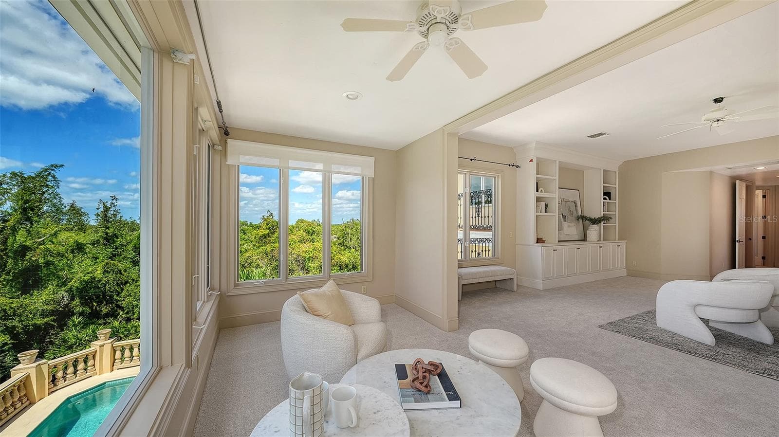 Large windows capture treetop and pool views while filling the primary retreat with beautiful natural light. - 168 COASTAL HAMMOCK CT, OSPREY