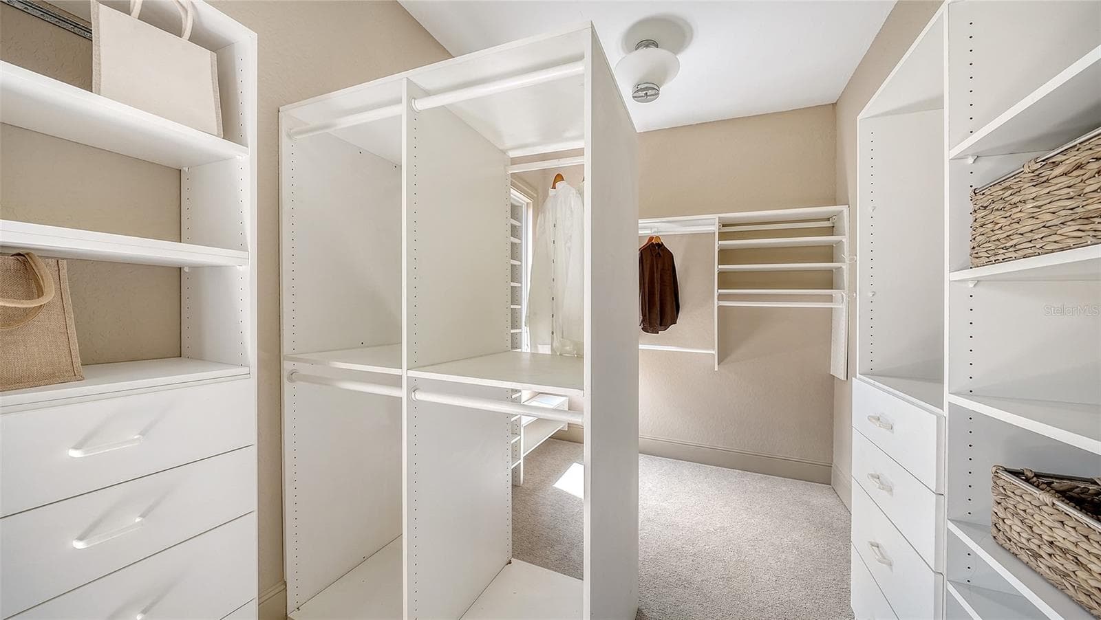 Custom designed storage provides extensive organization within the private primary suite level. - 168 COASTAL HAMMOCK CT, OSPREY
