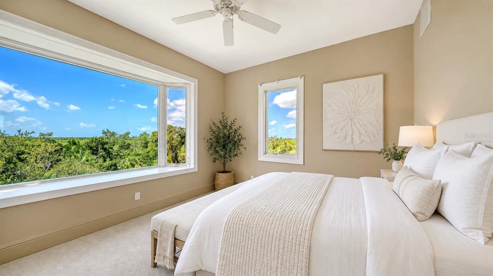 Bedroom Two (Virtually Staged) is a bright and inviting secondary bedroom enjoys beautiful treetop views and abundant natural light. - 168 COASTAL HAMMOCK CT, OSPREY