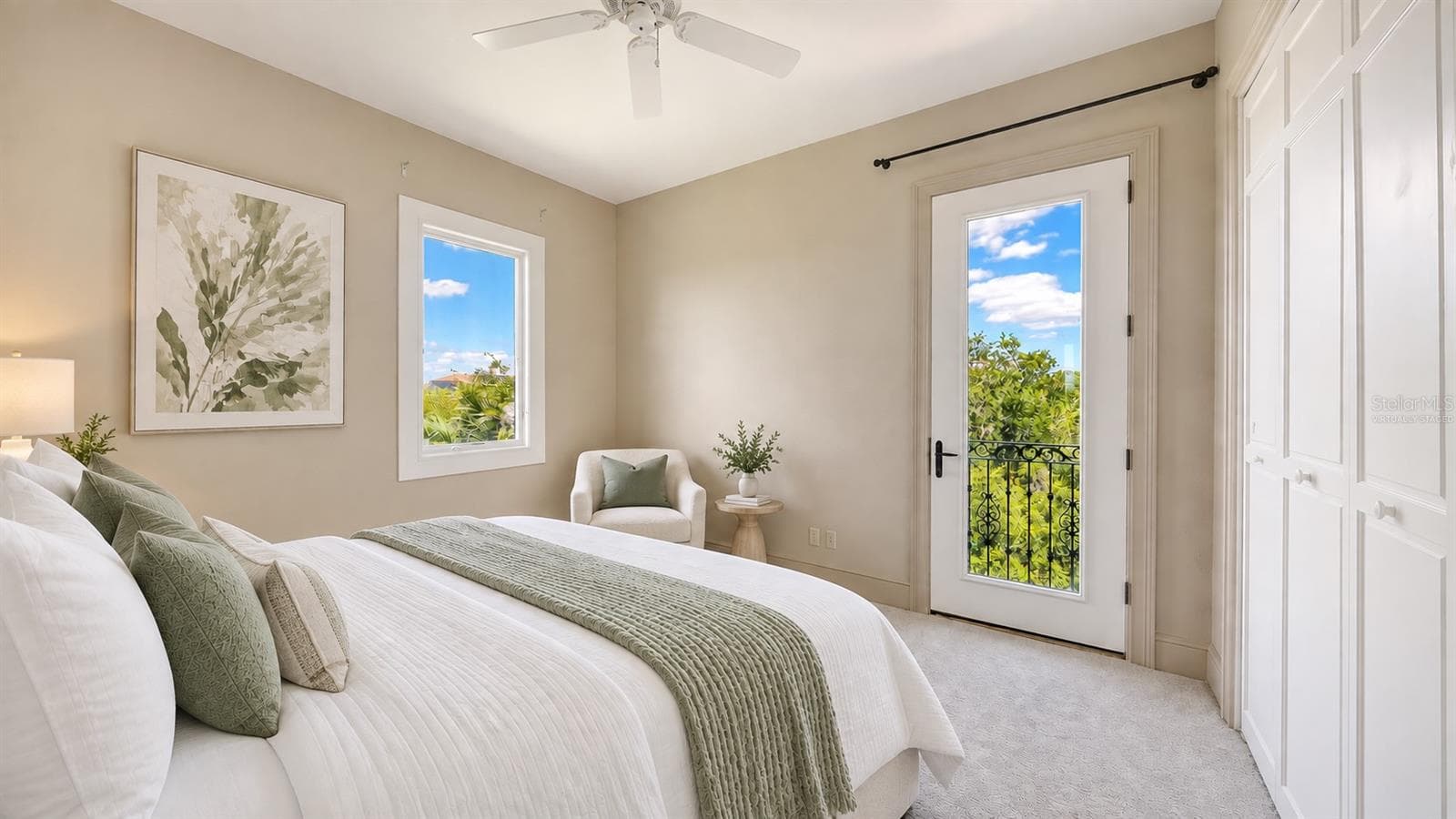 Bedroom Three (Virtually Staged) features a balcony with surrounding greenery in this peaceful and private upper level bedroom. - 168 COASTAL HAMMOCK CT, OSPREY