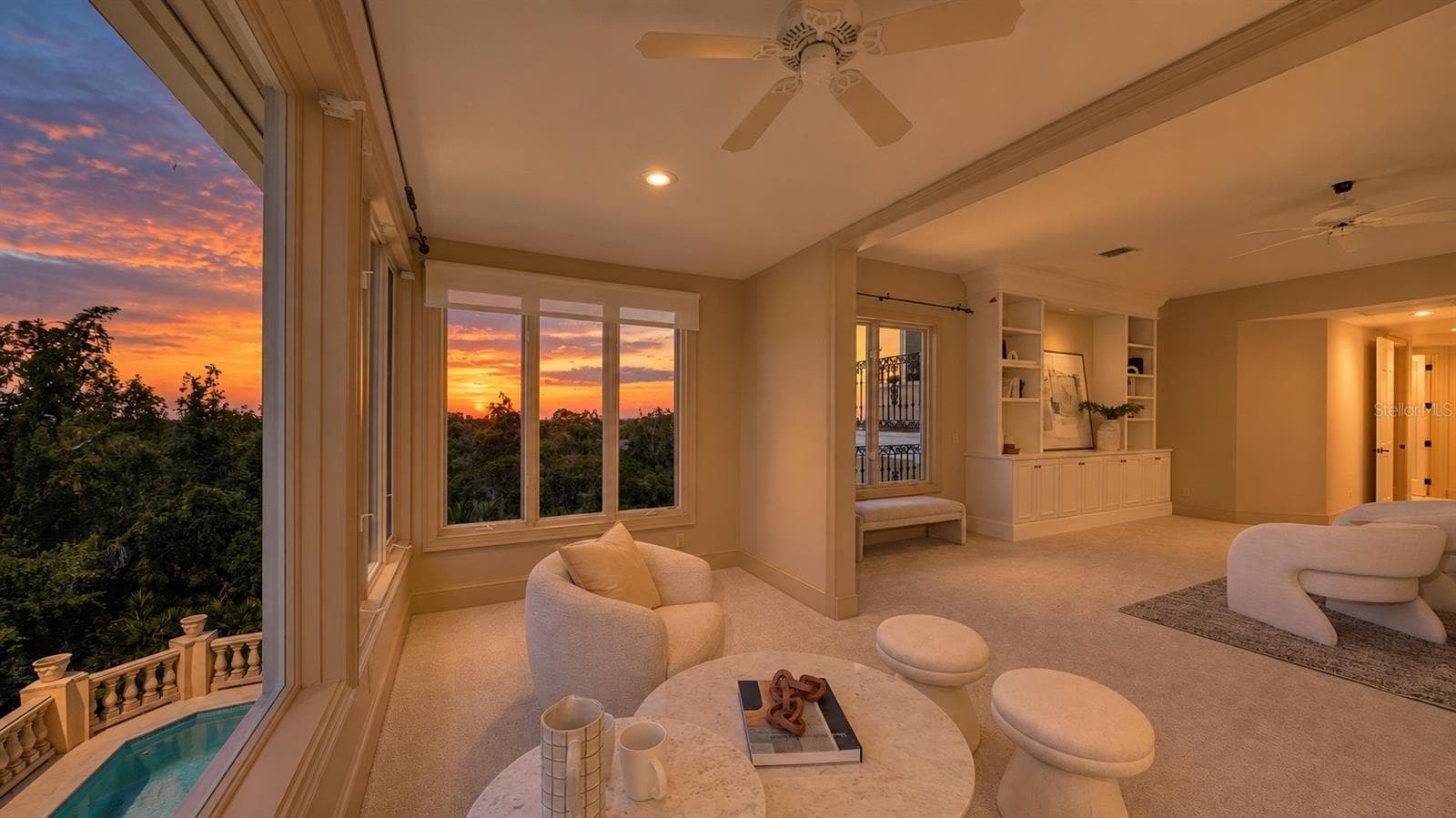 The primary sitting area captures the warm glow of sunset over the surrounding coastal landscape. - 168 COASTAL HAMMOCK CT, OSPREY