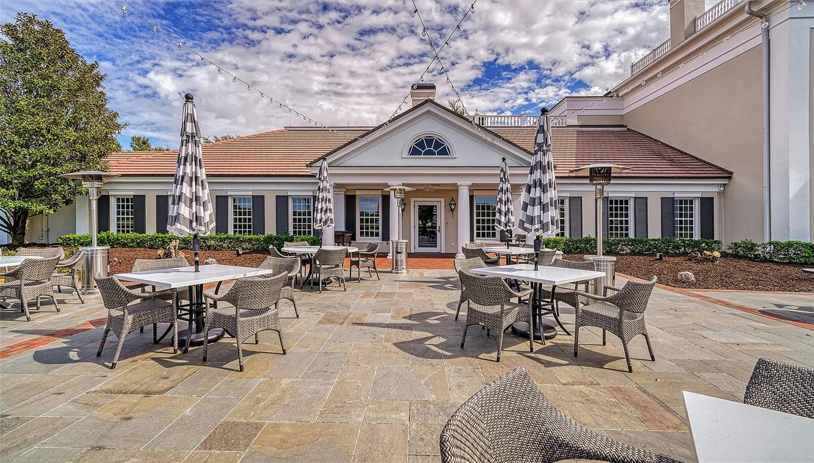 Enjoy the Florida lifestyle with inviting alfresco dining and gathering spaces within The Oaks. - 168 COASTAL HAMMOCK CT, OSPREY