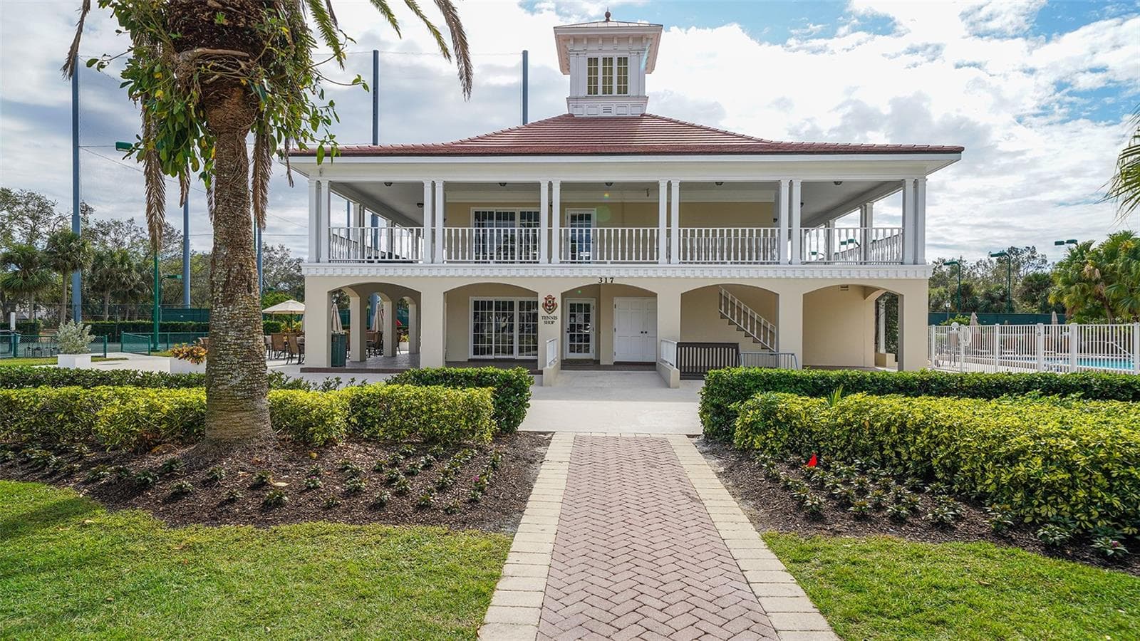 Timeless architecture and beautifully maintained grounds reflect the established character of The Oaks. - 168 COASTAL HAMMOCK CT, OSPREY