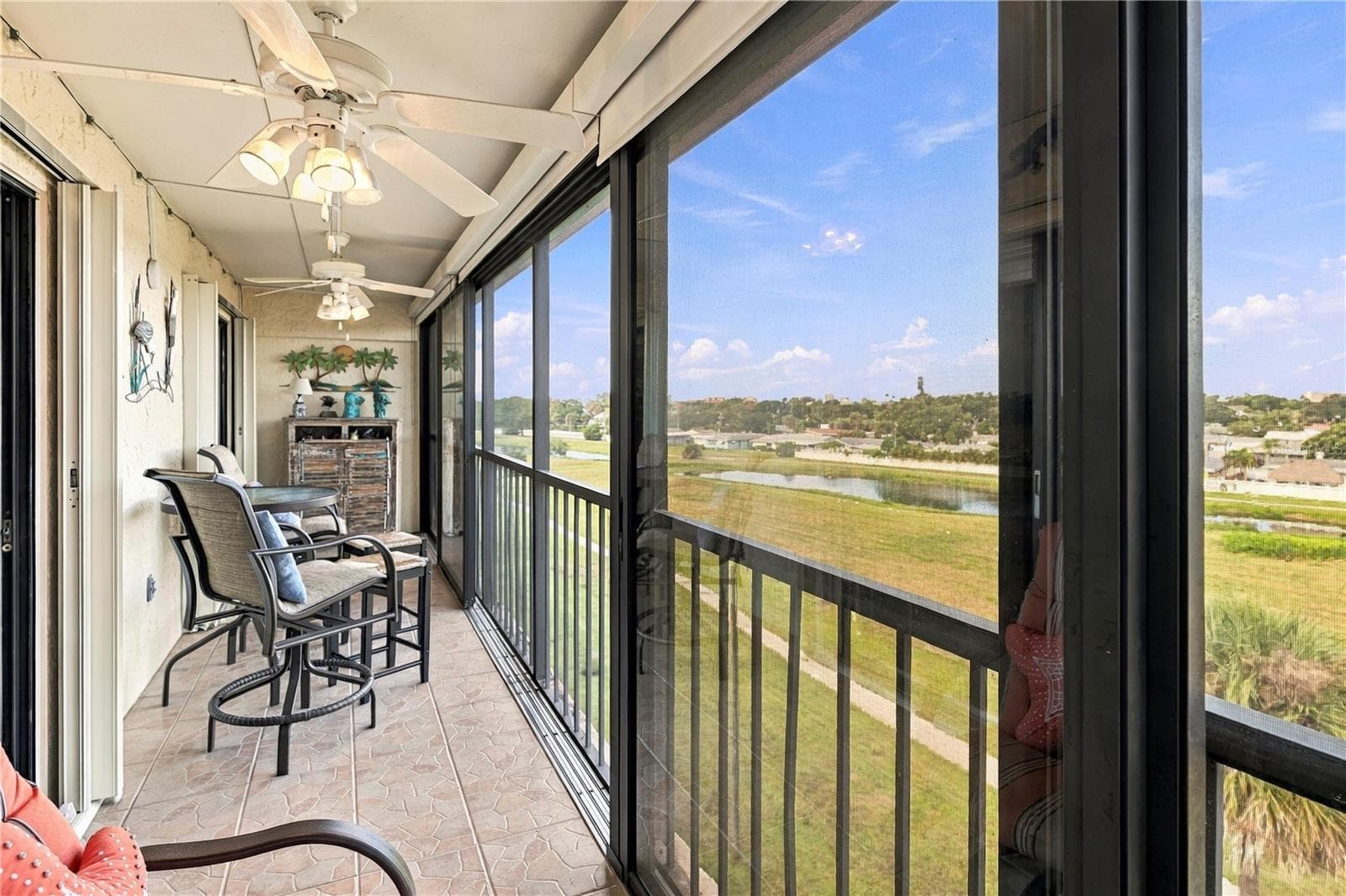 Glass sliding doors or open up to the screens. - 9490 HARBOR GREENS WAY #508, SEMINOLE