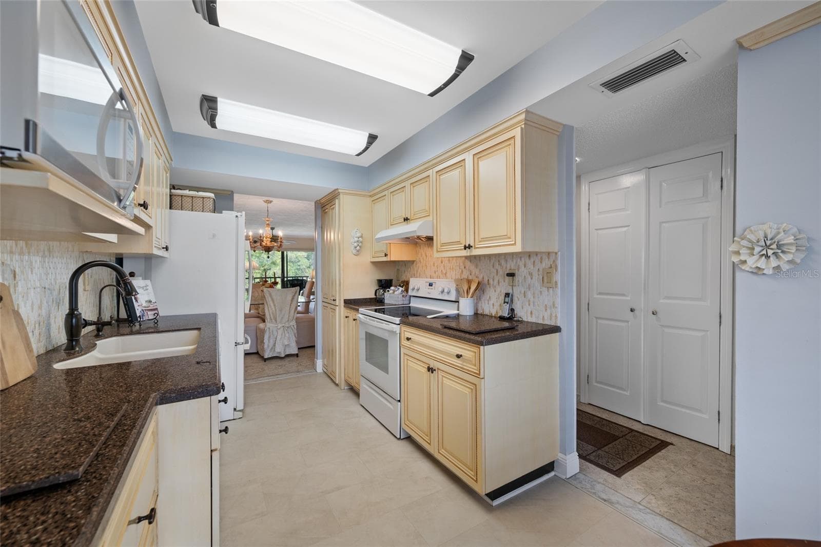 Kitchen with Closet Pantry - 2700 COVE CAY DR #1-3B, CLEARWATER