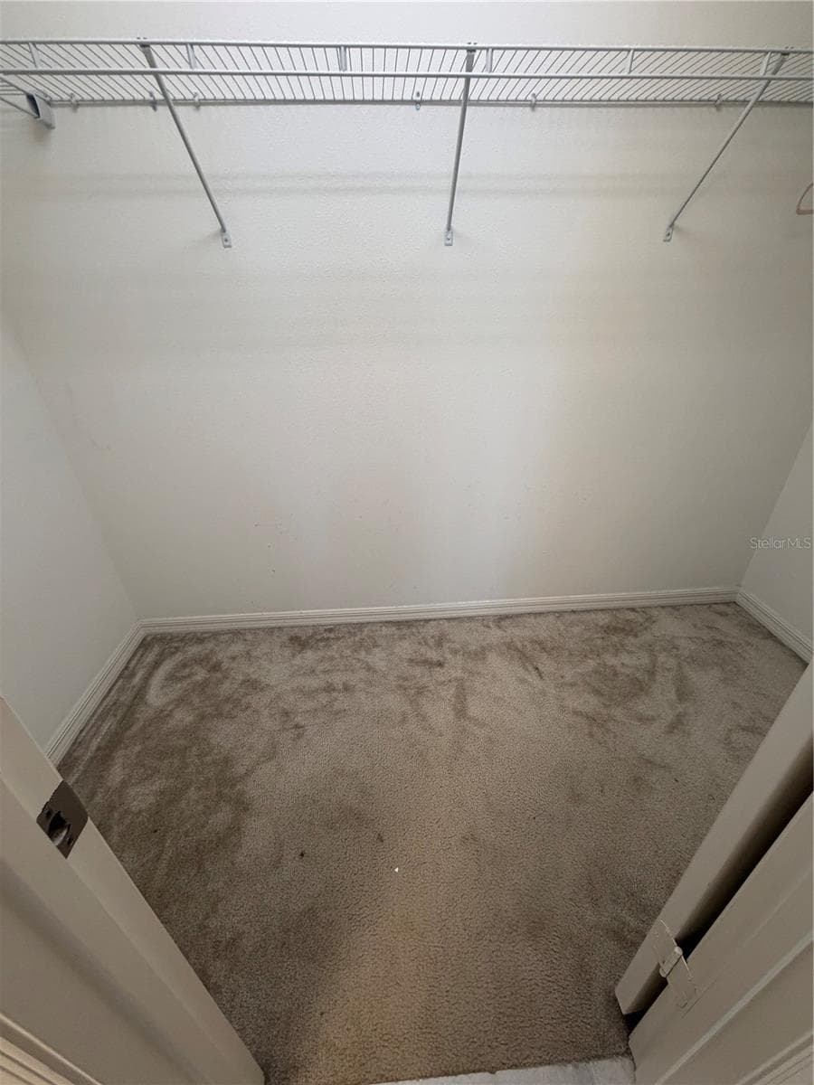Walk-in closet in Primary Bedroom - 2500 BEGONIA ST, MASCOTTE