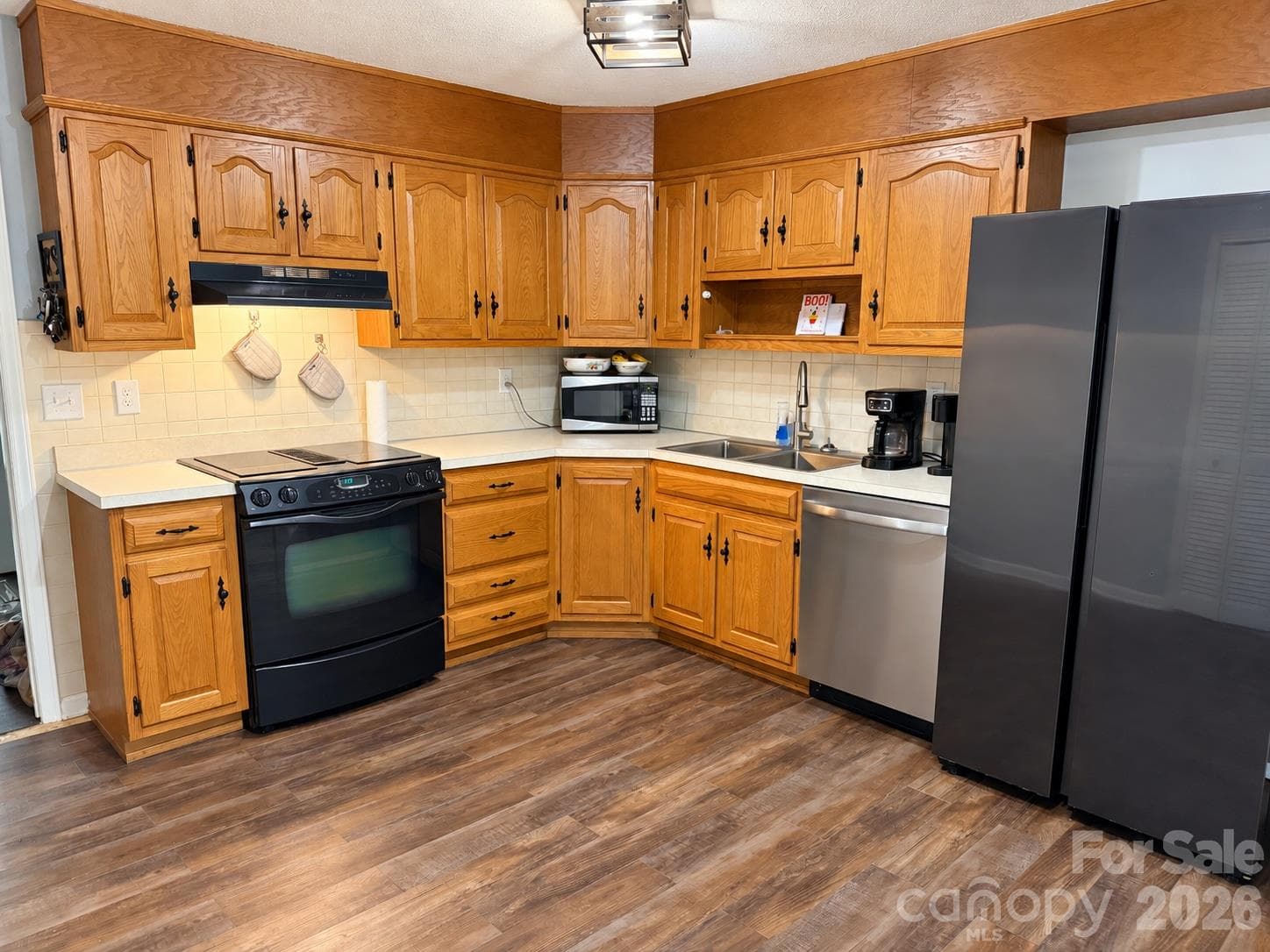 main level kitchen with NEW floors which now match the entire main level - 92 Greenwood Acres Drive, Mills River