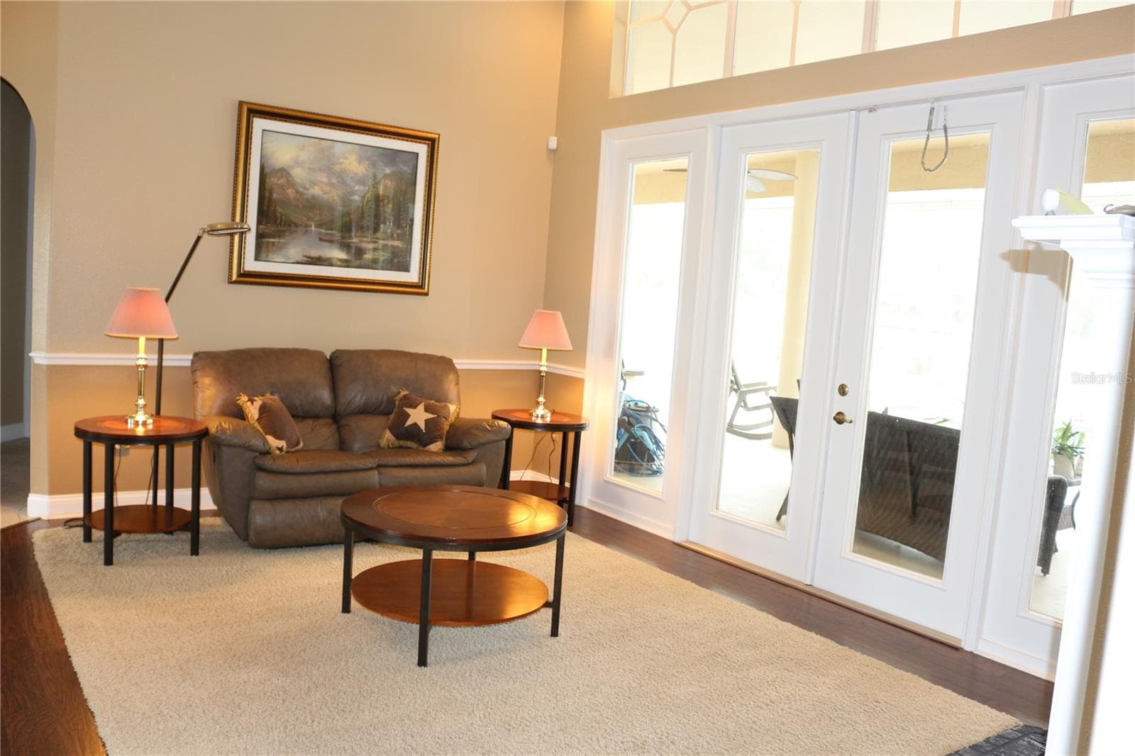 Bright sitting area with expansive windows overlooking the grounds - 6722 W SENTINEL BLUFF PATH, BEVERLY HILLS