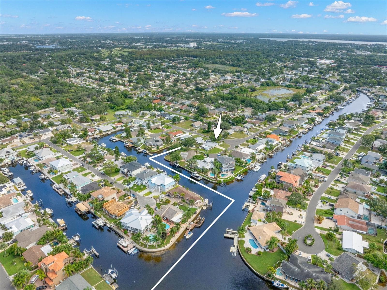 A dramatic aerial view captures Baywood Village’s interconnected canal system and the boating lifestyle that defines the neighborhood, with waterfront homes, private docks, and direct saltwater access throughout the community. - 332 WESTWINDS DR, PALM HARBOR