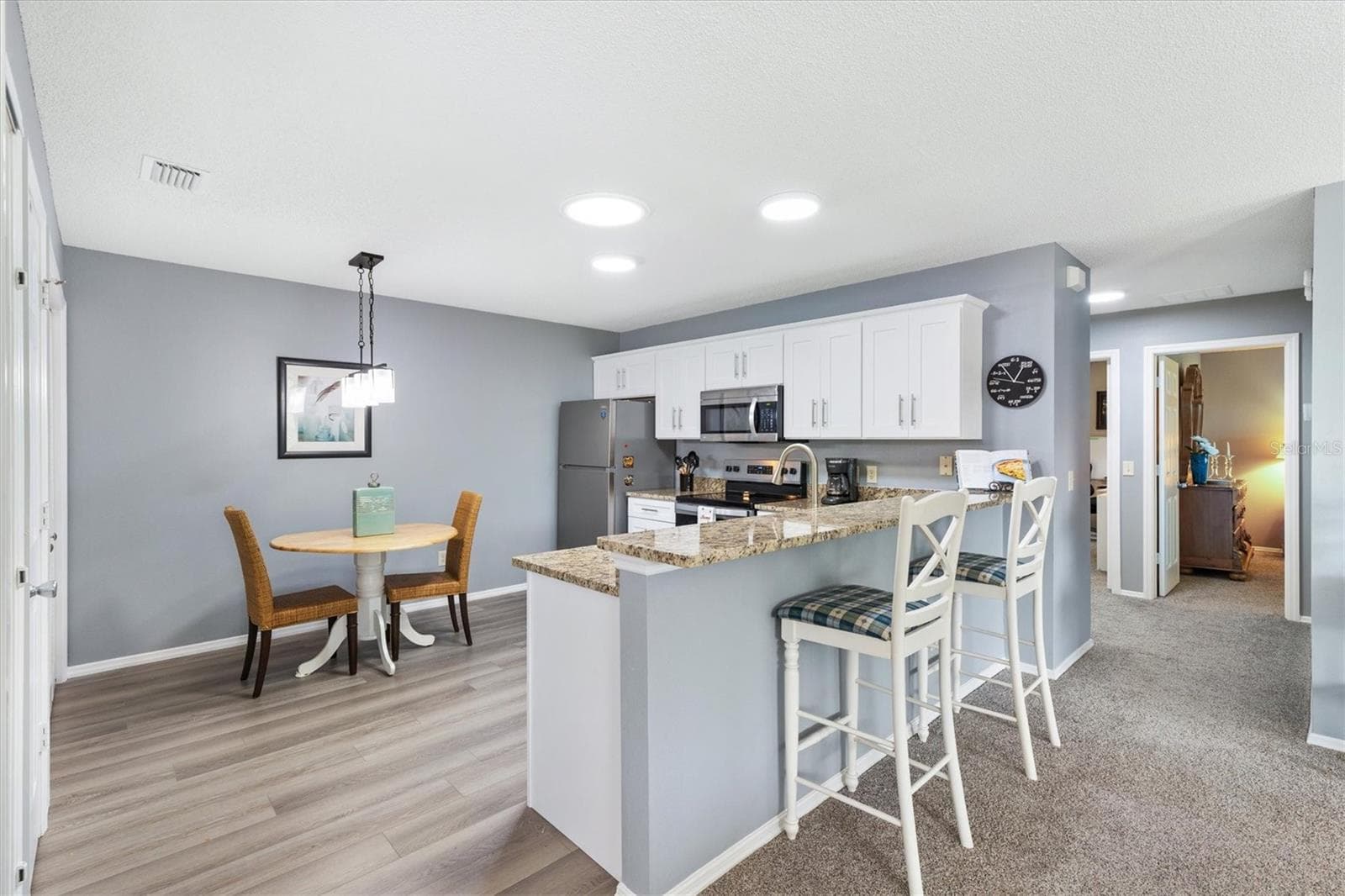 OPEN CONCEPT LIVING ROOM & KITCHEN,DINING ROOM - 1234 EAGLE RIDGE DR, THE VILLAGES