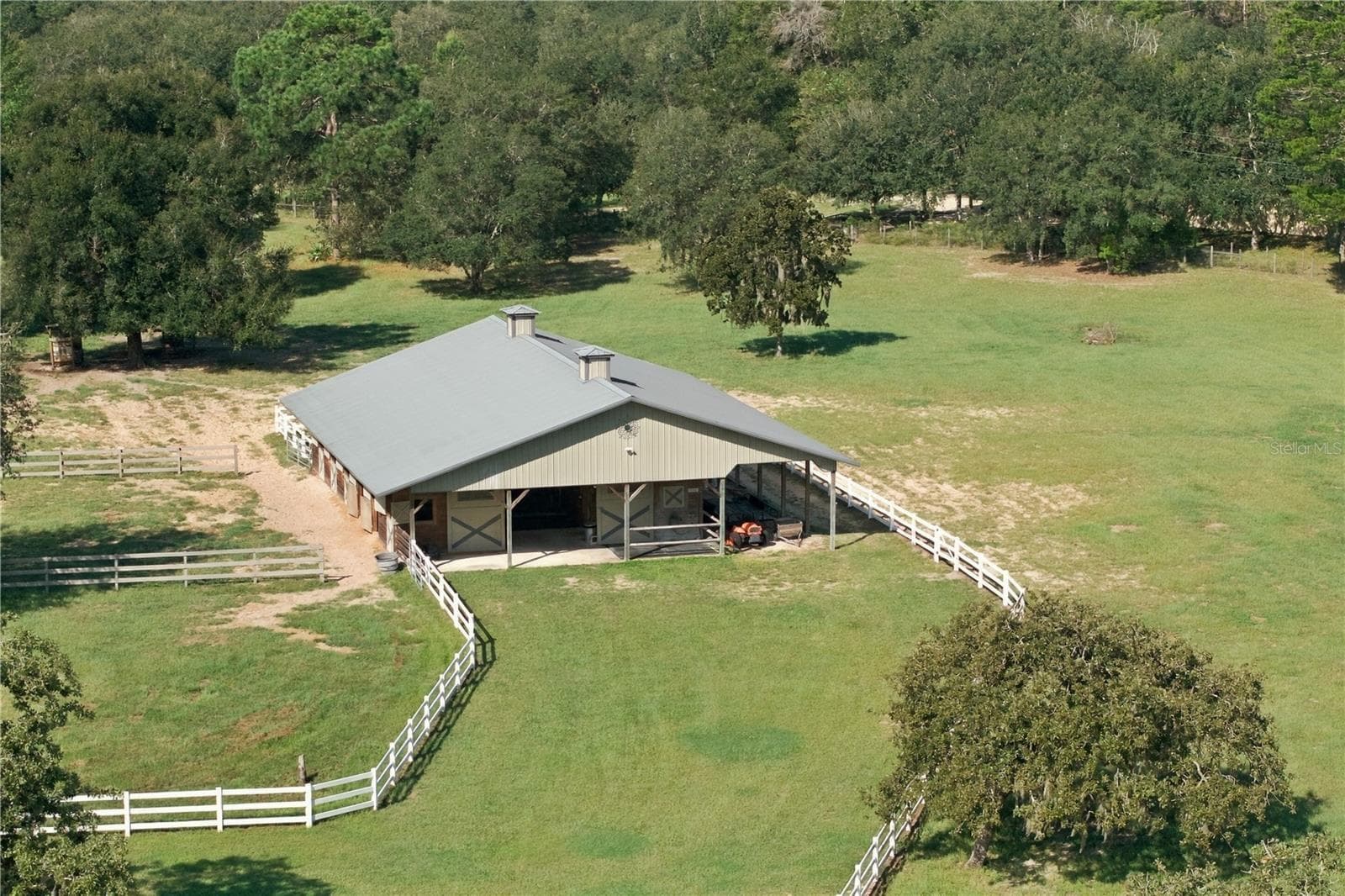 Ariel view showcases the barn, fenced pastures and beautiful acreage - 6722 W SENTINEL BLUFF PATH, BEVERLY HILLS