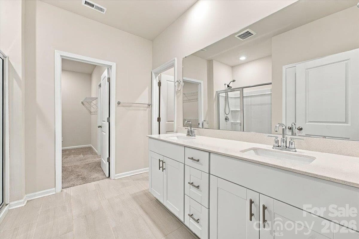 Primary bath with large walk-in closet and cut through to laundry room- genius! - 151 Bird Dog Drive, Mooresville