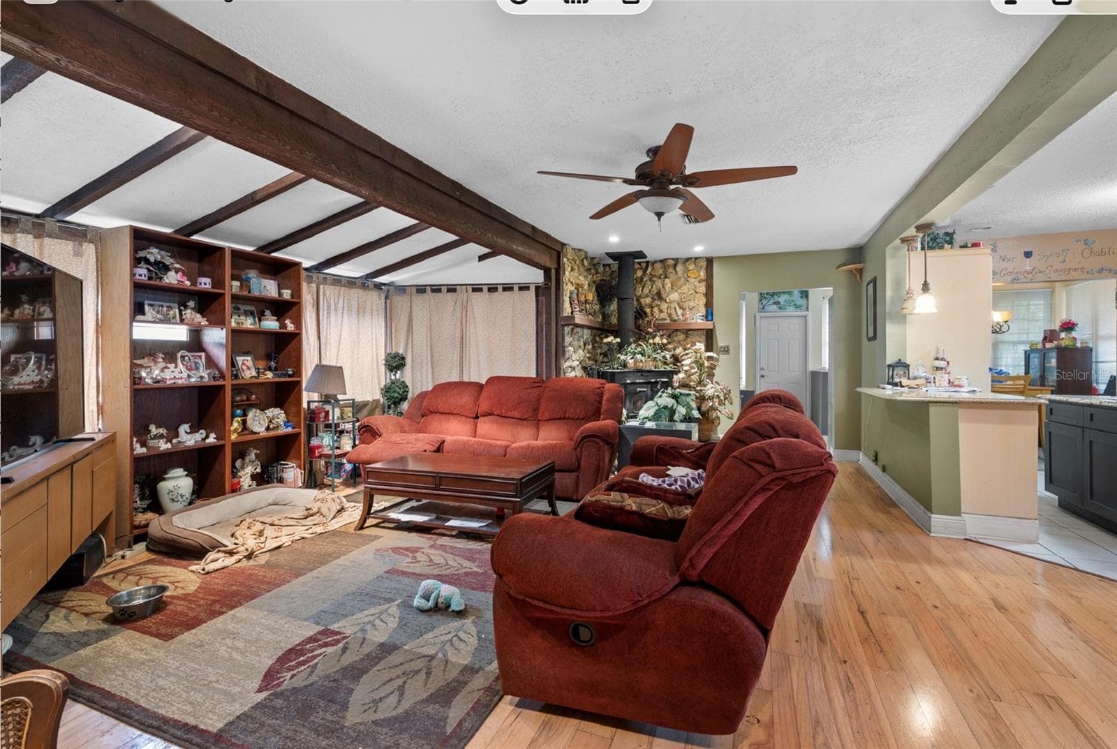 view of living room looking back at front door and kitchen to the right - 8602 N ROME AVE, TAMPA