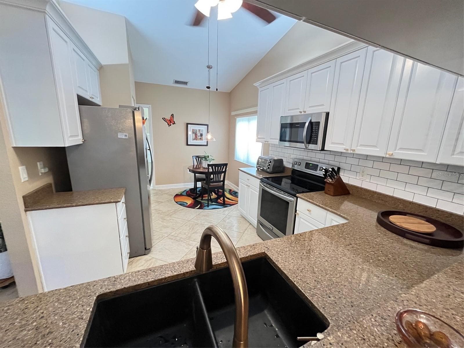 GRANITE COUNTERTOPS AND SUBWAY TILE BACKSPLASH - 6905 STONE RIVER, BRADENTON