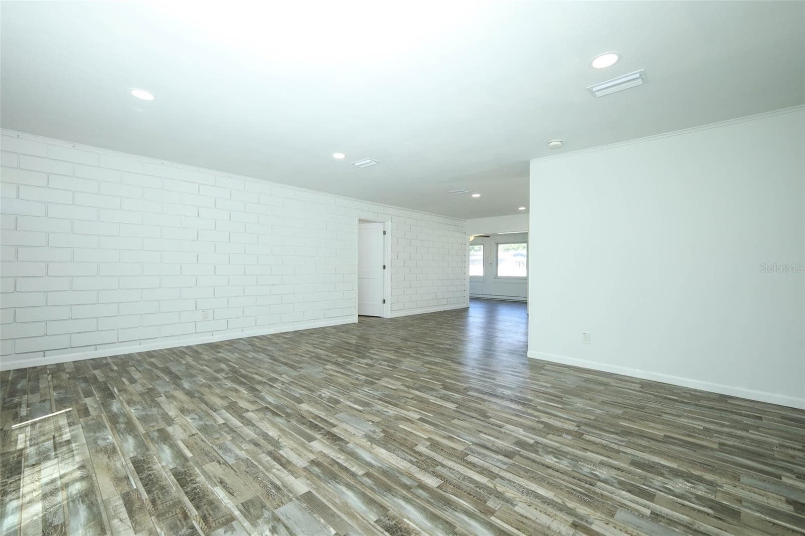 Living room looking into dining and Florida Room. Look at that brick wall!! - 60 PARK LN, DEBARY