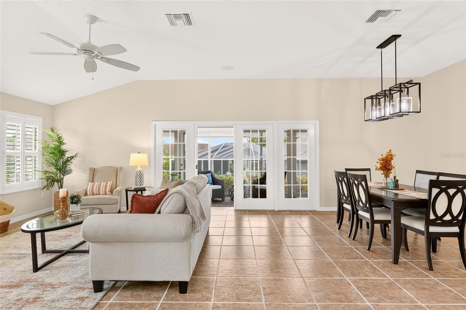 An inviting OPEN LIVING AREA flows seamlessly into the kitchen and dining space, creating a welcoming setting for entertaining, conversation, and everyday relaxation. - 2454 MORNING DOVE LN, THE VILLAGES