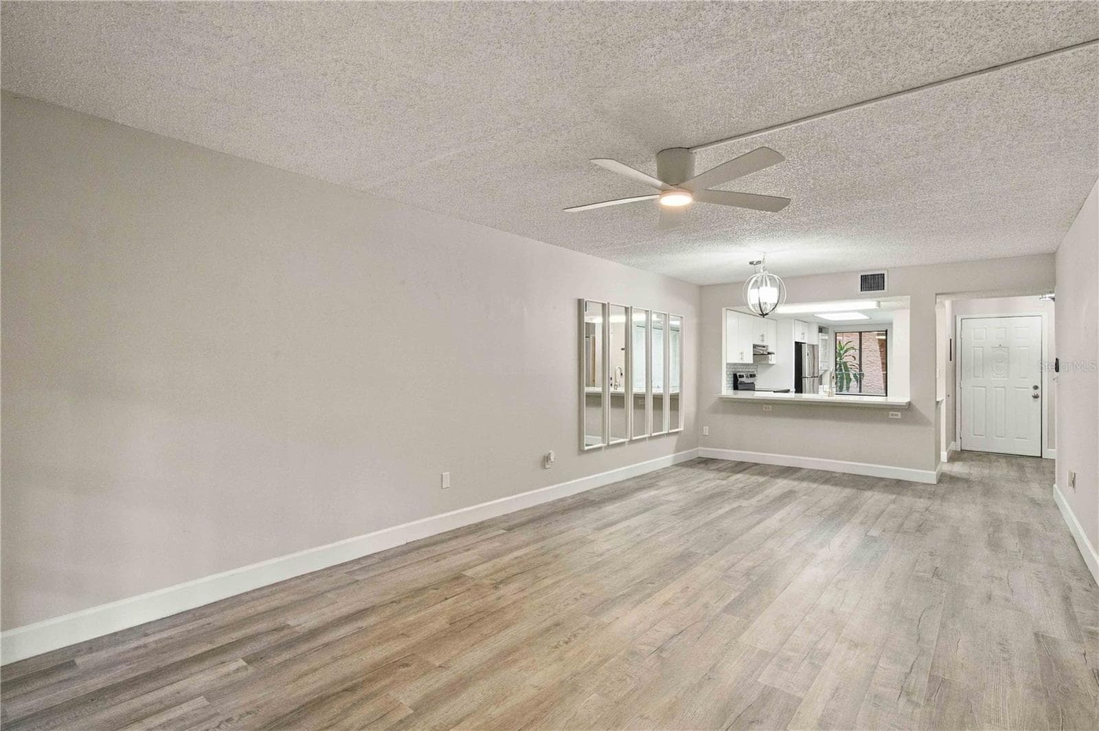 Living Room and Dining Room looking towards the kitchen. - 7500 40TH AVE W #105, BRADENTON