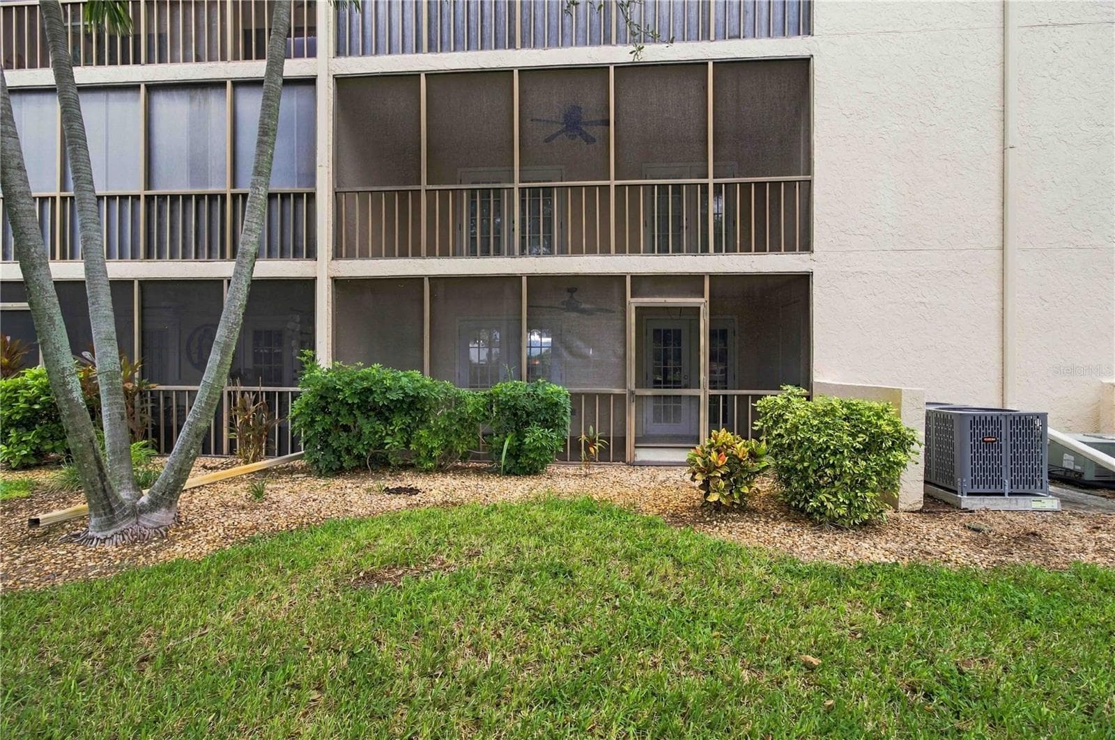 Exterior looking toward lanai from yard. - 7500 40TH AVE W #105, BRADENTON
