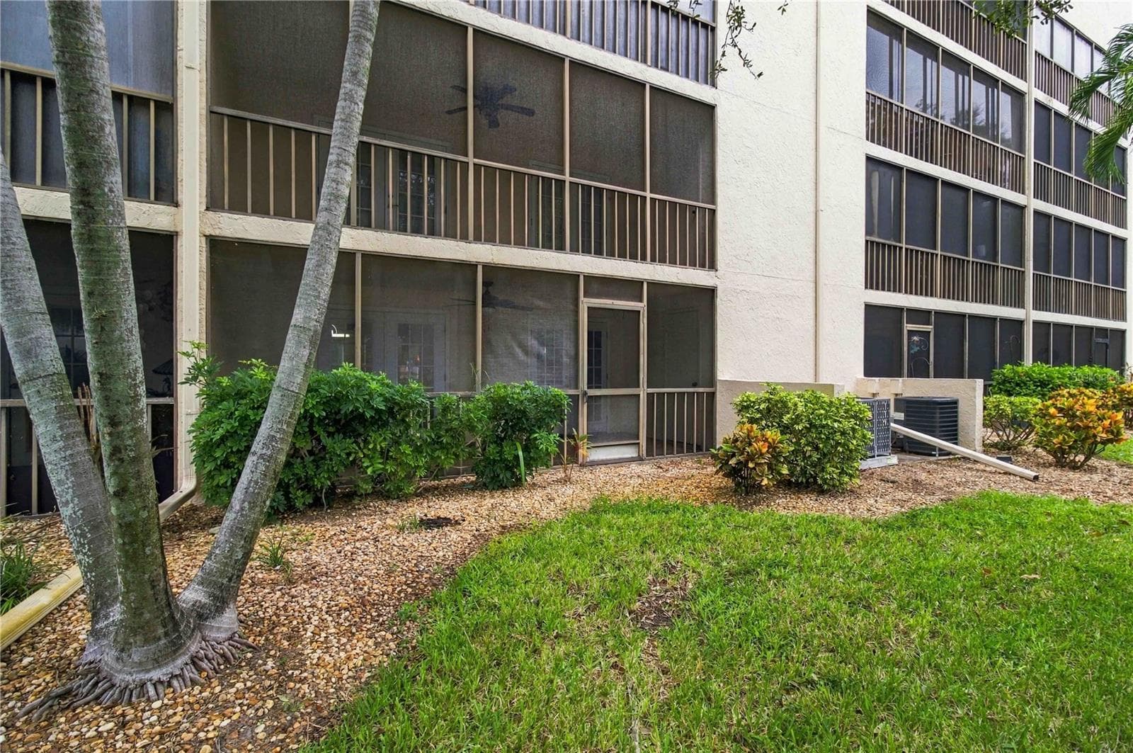 Exterior looking toward lanai from yard. - 7500 40TH AVE W #105, BRADENTON