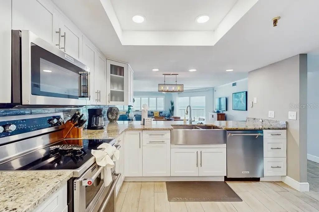 STATE-OF-THE-ART KITCHEN FEATURING STAINLESS STEEL APPLIANCES AND DOUBLE OVEN - 18400 GULF BLVD #1208, INDIAN SHORES