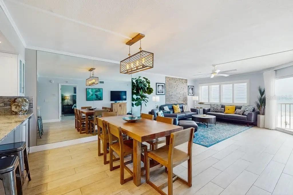 AMPLE GREAT ROOM AREA WITH STUNNING BEACH VIEWS, NATURAL STONE WOOD-BURNING FIREPLACE,  AND OPEN KITCHEN COUNTER WITH ADDITIONAL WINE FRIDGE. - 18400 GULF BLVD #1208, INDIAN SHORES