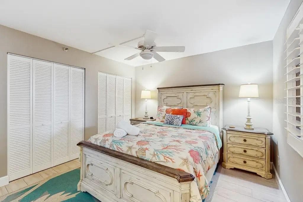 THIRD BEDROOM FEATURES DOUBLE CLOSETS, QUEEN SIZE BED, PLANTATION SHUTTERS, FLAT TV, AND CEILING FAN - 18400 GULF BLVD #1208, INDIAN SHORES