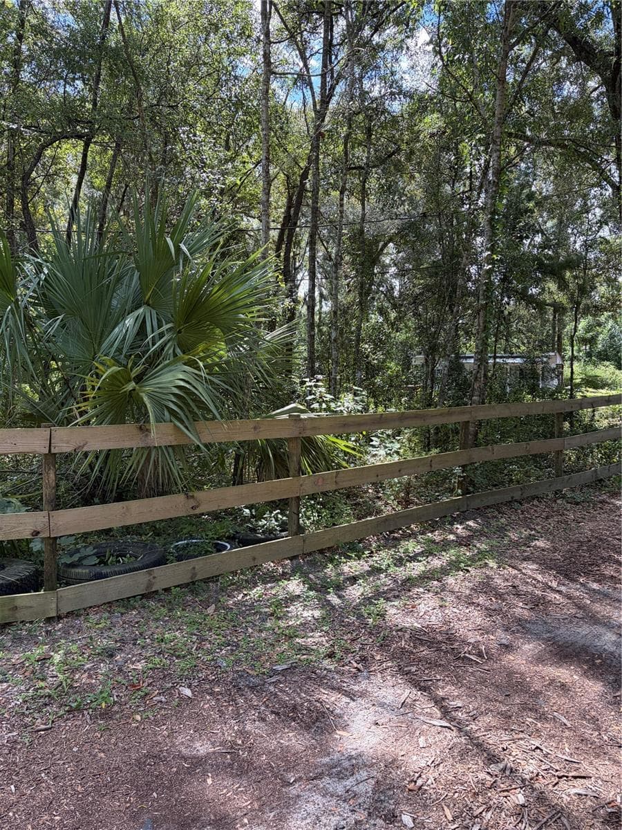 around the front and sides of property, barbed wire in the back yard behind all the trees - 6401 SUNNYSIDE RANCH RD, BROOKSVILLE