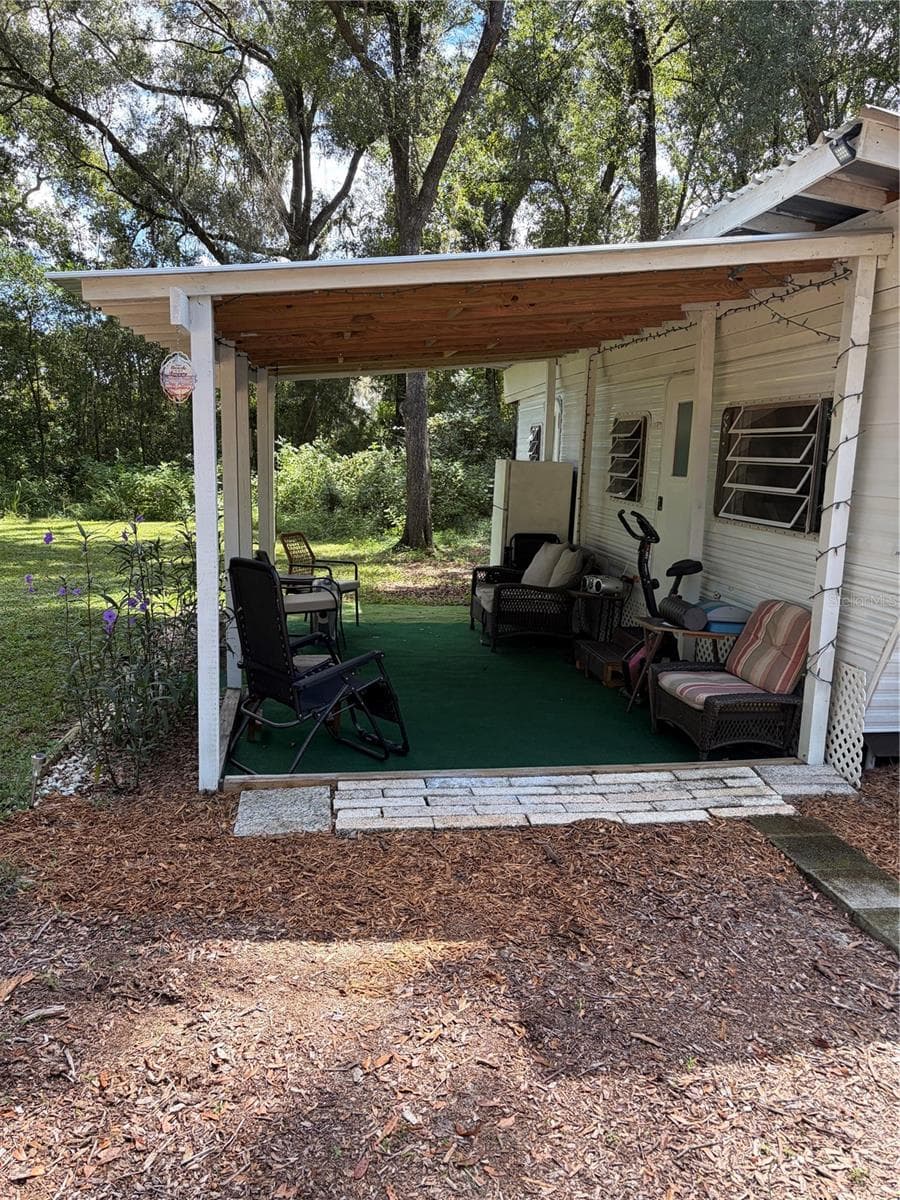 front porch at the rv 15 x 10 metal roof, ready to rent or use as guest house - 6401 SUNNYSIDE RANCH RD, BROOKSVILLE