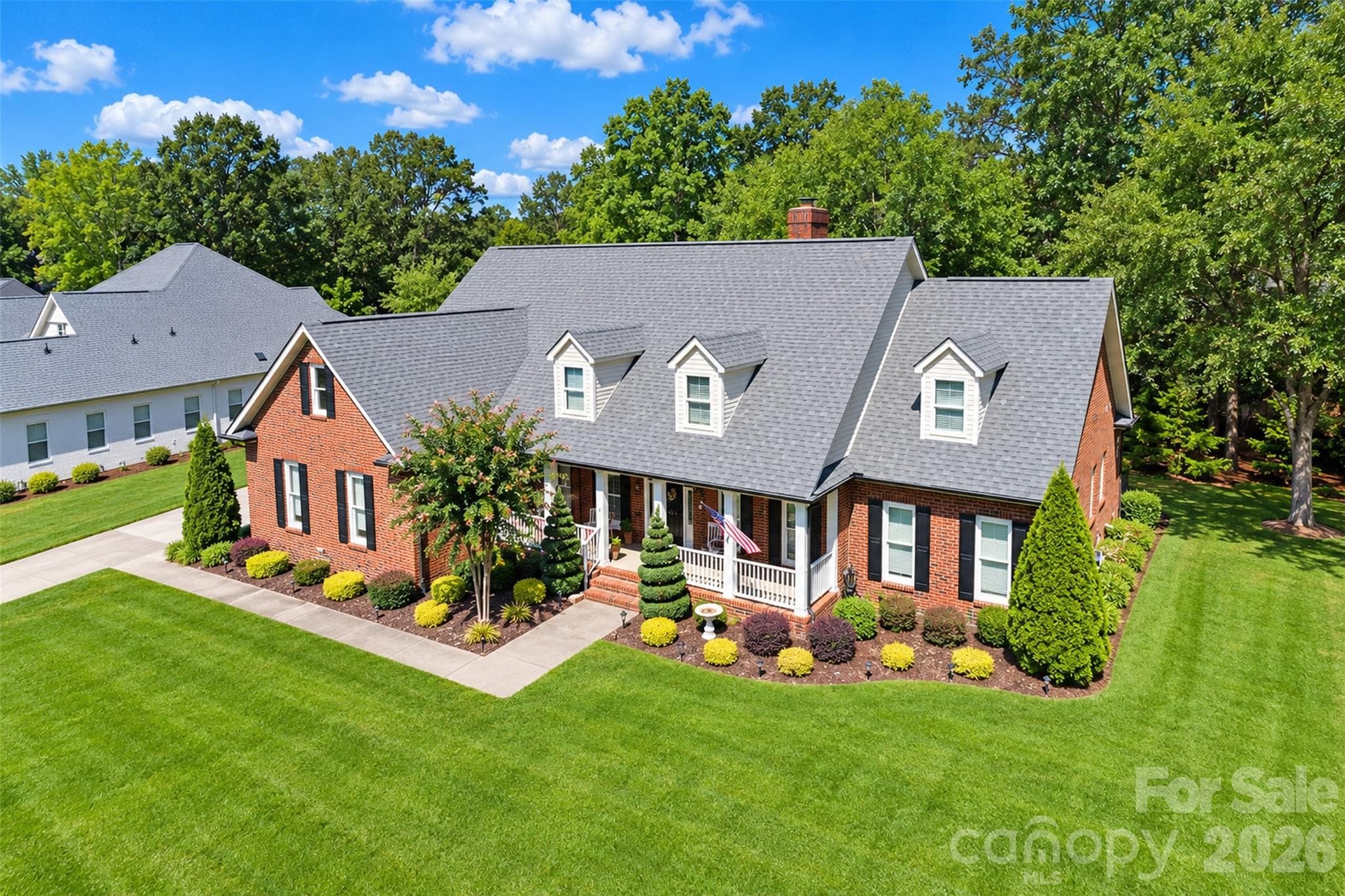 Expansive flat lot with great shady trees. Profesional Designed Landscaping with Irrigaton System in place (2020). Two gorgeous Spiral Cedar trees, lenten roses, kaleidoscope, midget french plant and a hydrangea await you for Spring blooming. Lawn aeriation done Oct 2026. Crawl Space was pre inspected separately. Right side of house has a big area planted with Irises and Day Lillies (Spring). New FASCIA boxing (2022) and new Upstairs windows (2015). Convenient Multiple-Car Driveway estimated for 10 cars. - 5480 Glen Forest Drive, Charlotte