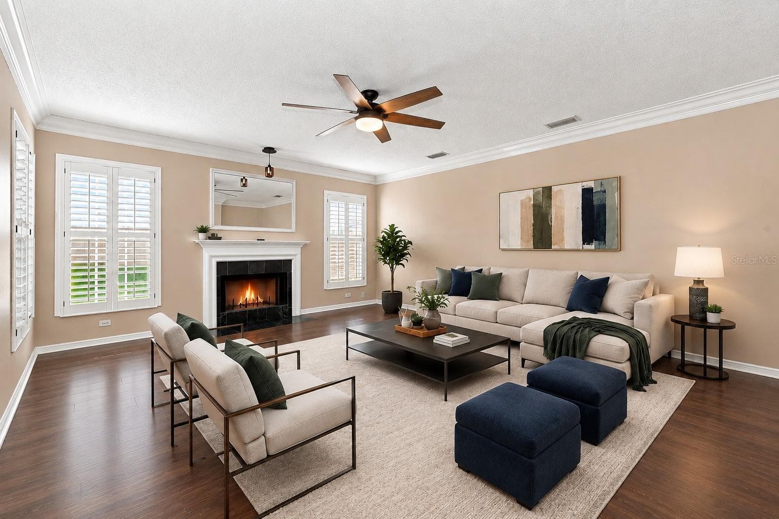 Spacious Formal Living Room featuring BRAND NEW LVP flooring, crown molding, plantation shutters, and a cozy wood-burning fireplace. - 1349 VALLEY PINE CIR, APOPKA