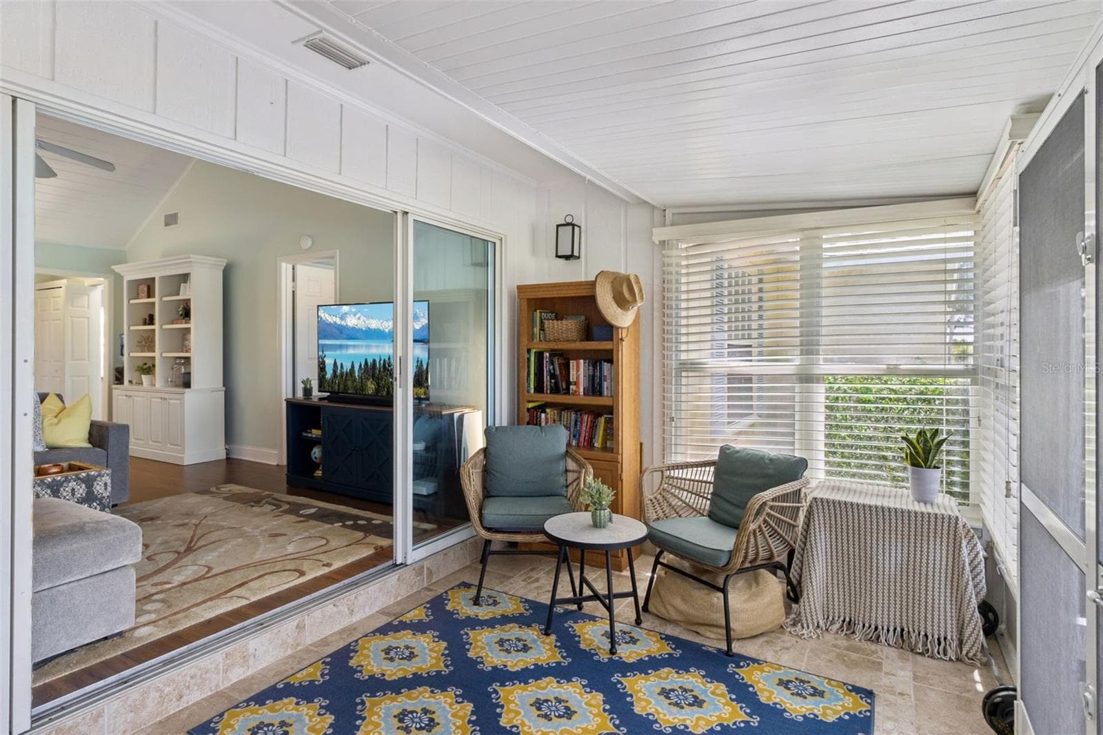 Open the four-panel sliding glass doors to the sunroom. - 1066 VILLA LN #63, APOPKA