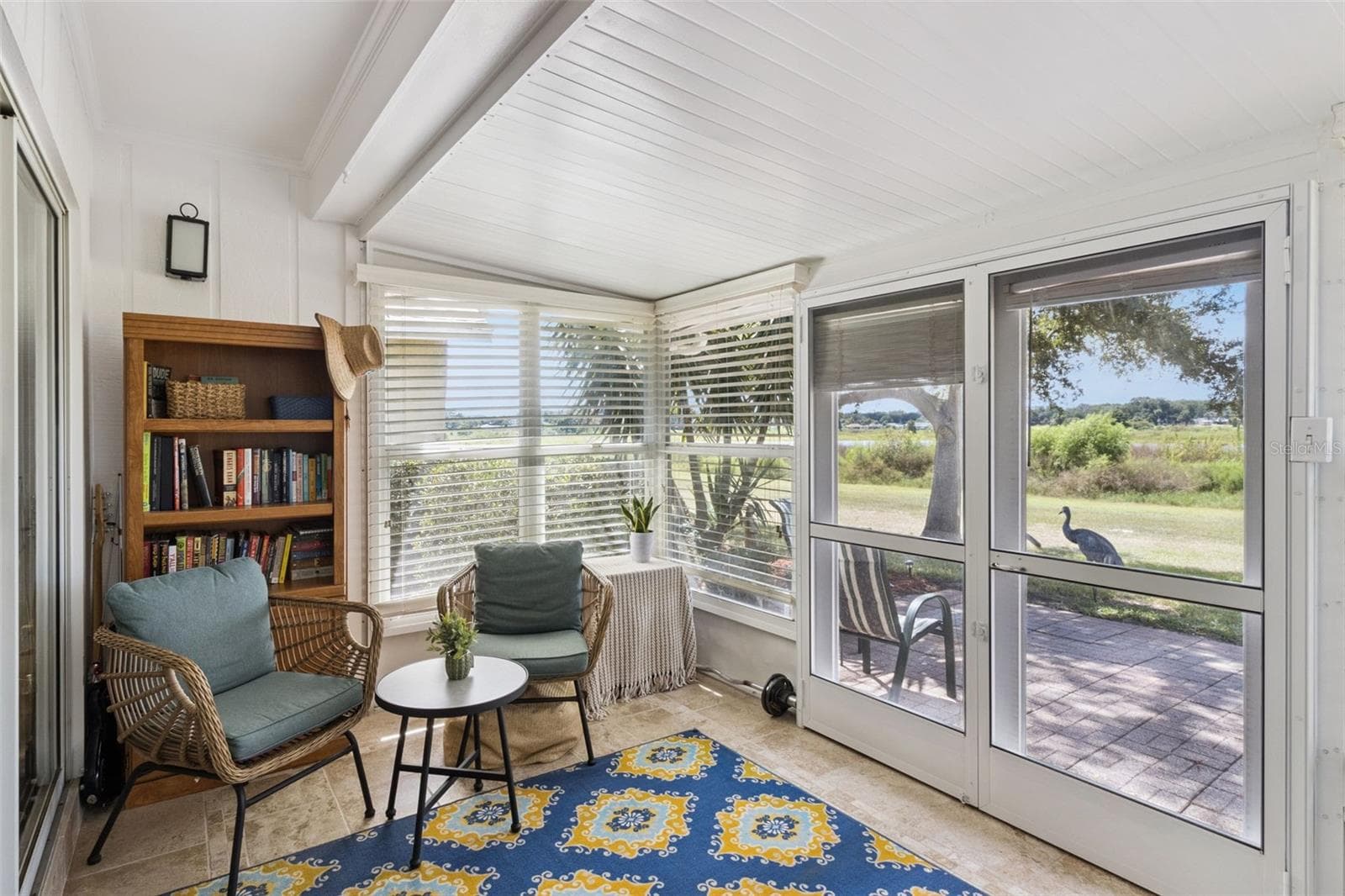 French doors with center-opening screens lead to the patio when you want the breeze. - 1066 VILLA LN #63, APOPKA