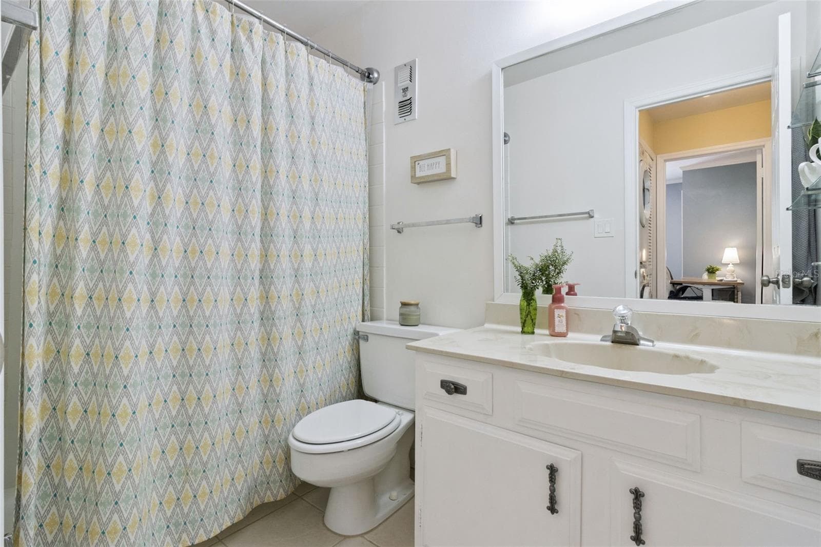 The second bathroom features a marble vanity with integrated sink and tub with shower. - 1066 VILLA LN #63, APOPKA
