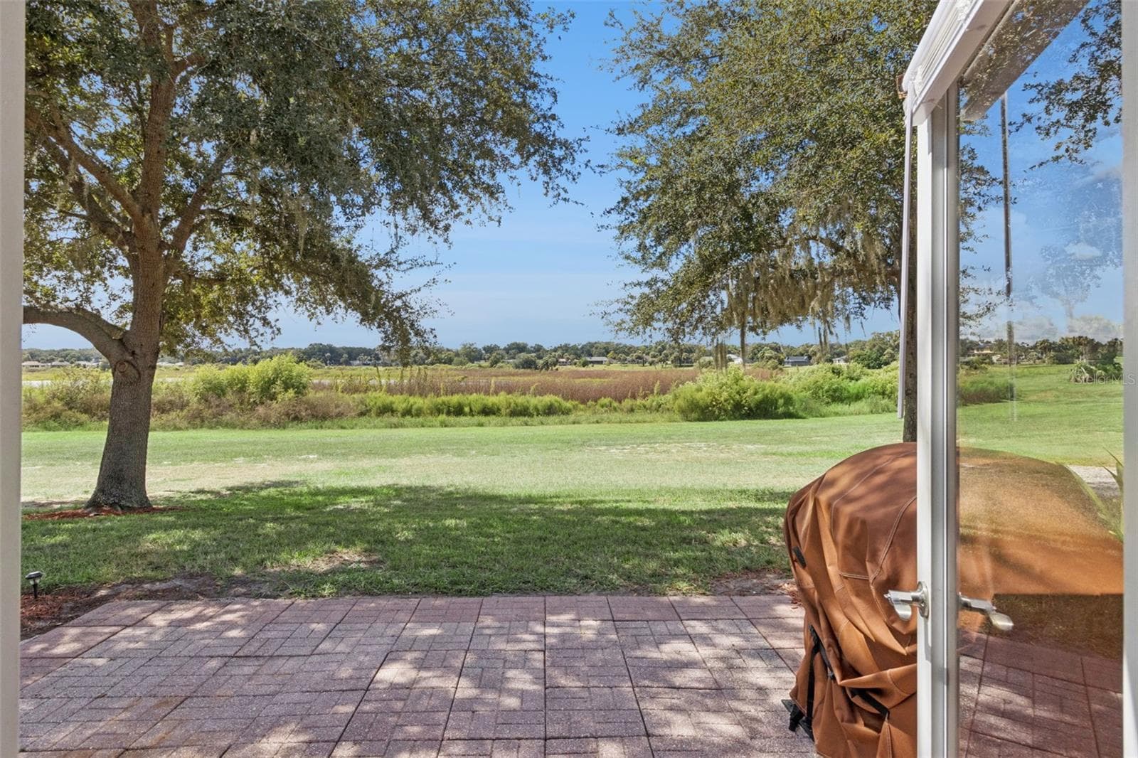 From your spacious paver patio, watch the glorious sunsets unfold over large Lake Alden. - 1066 VILLA LN #63, APOPKA